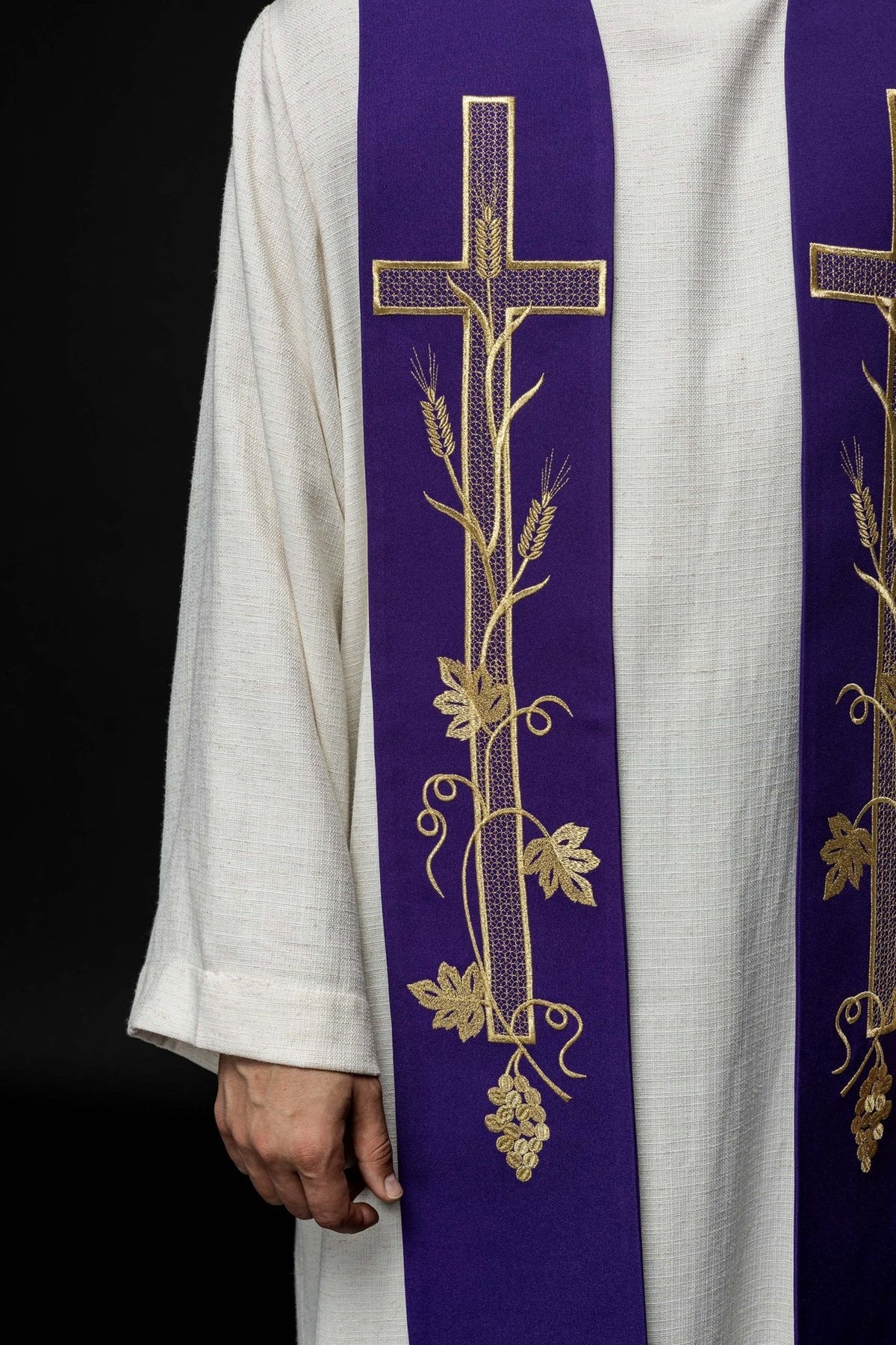 Purple priest stole close-up showing gold cross, wheat, vine and floral embroidery