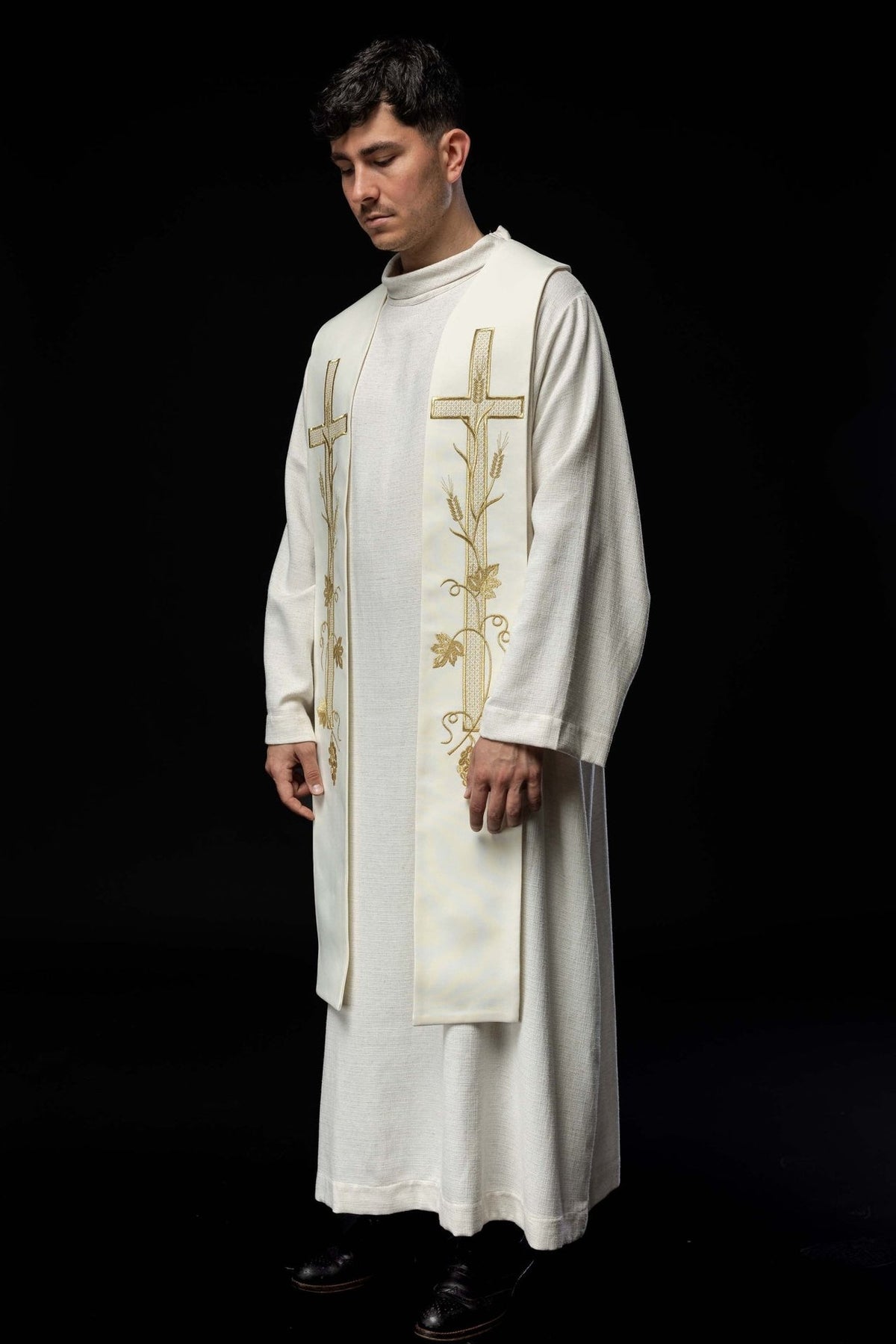 Ecru stole worn in a three-quarter view with matching gold cross and vine embroidery