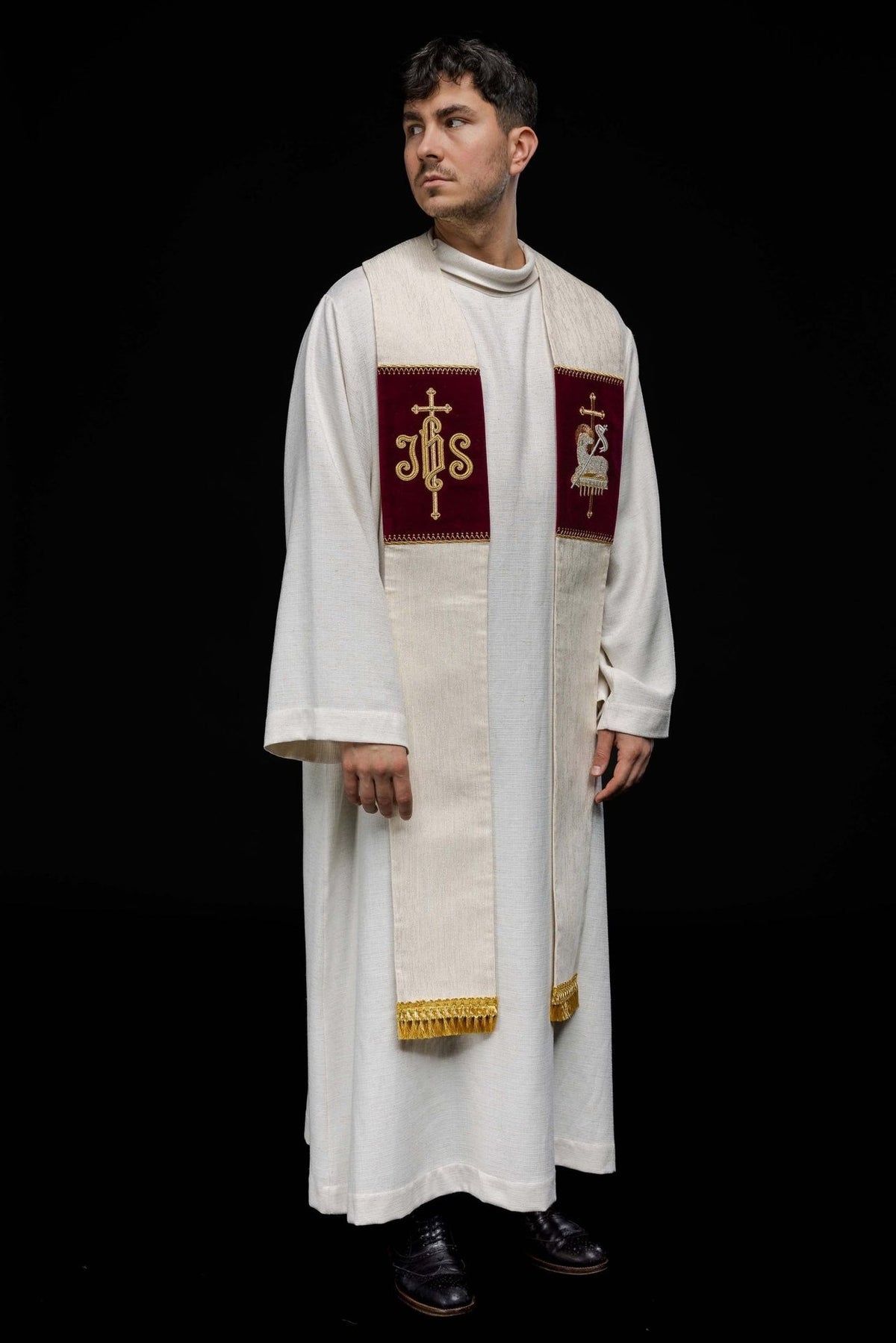 Embroidered stole worn at an angle, showing both burgundy symbol panels and gold fringe