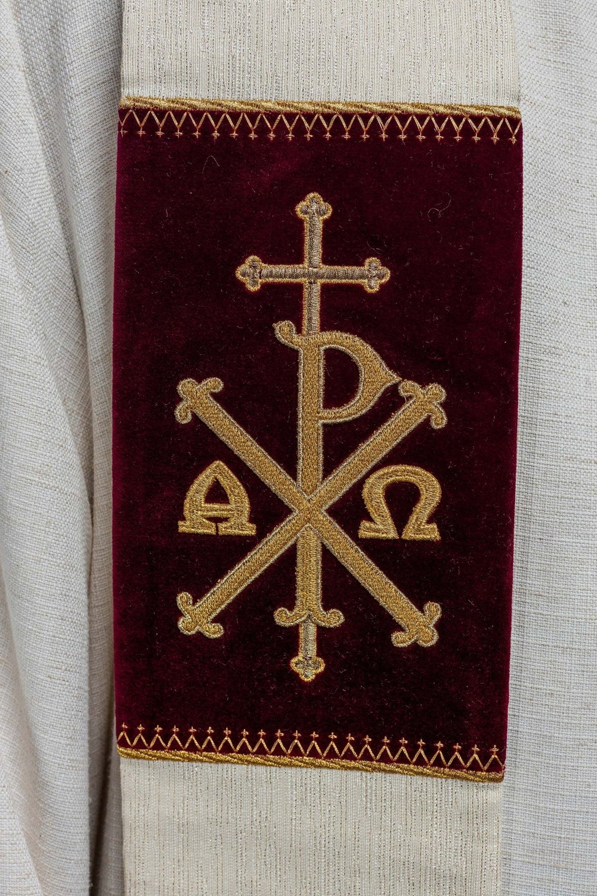Stole with gold embroidered PAX symbol on a burgundy panel