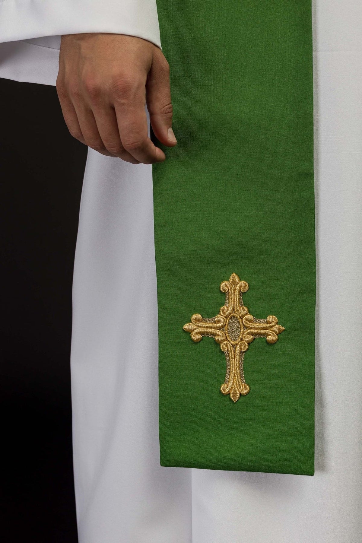 Green priest stole close-up showing embroidered gold cross