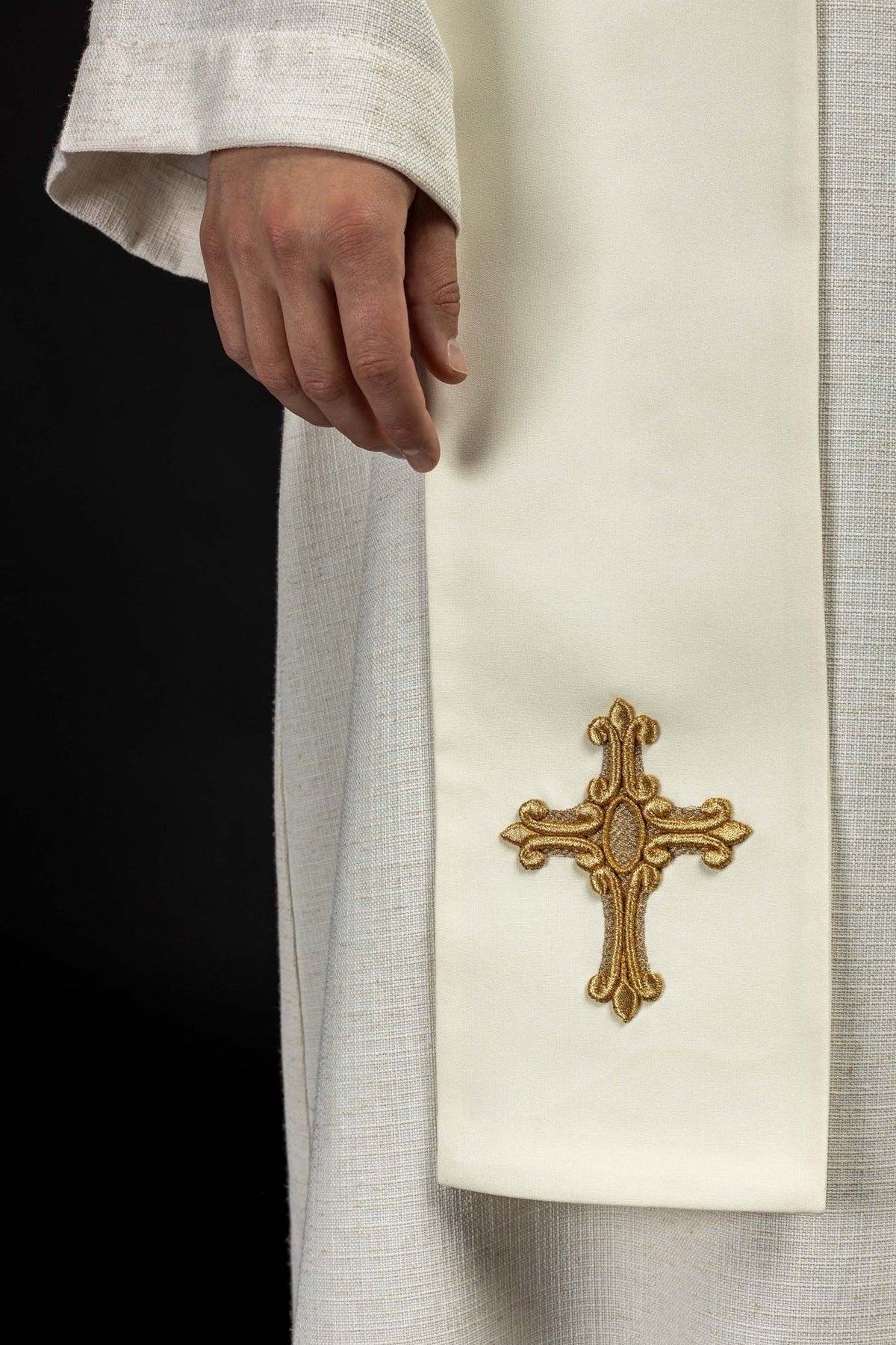 Ecru priest stole close-up showing a gold cross embroidery