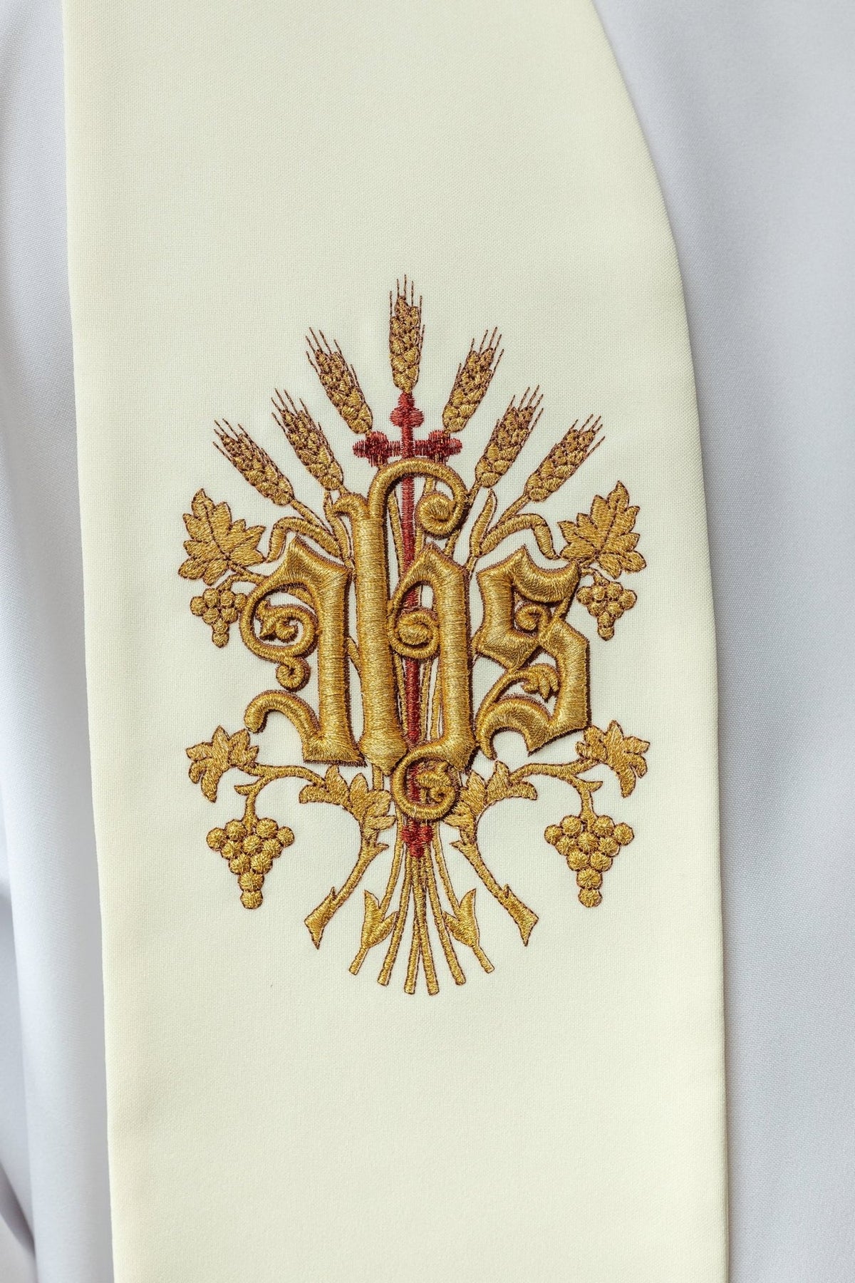 Ecru stole close-up showing embroidered IHS motif with wheat, grapes and leaves