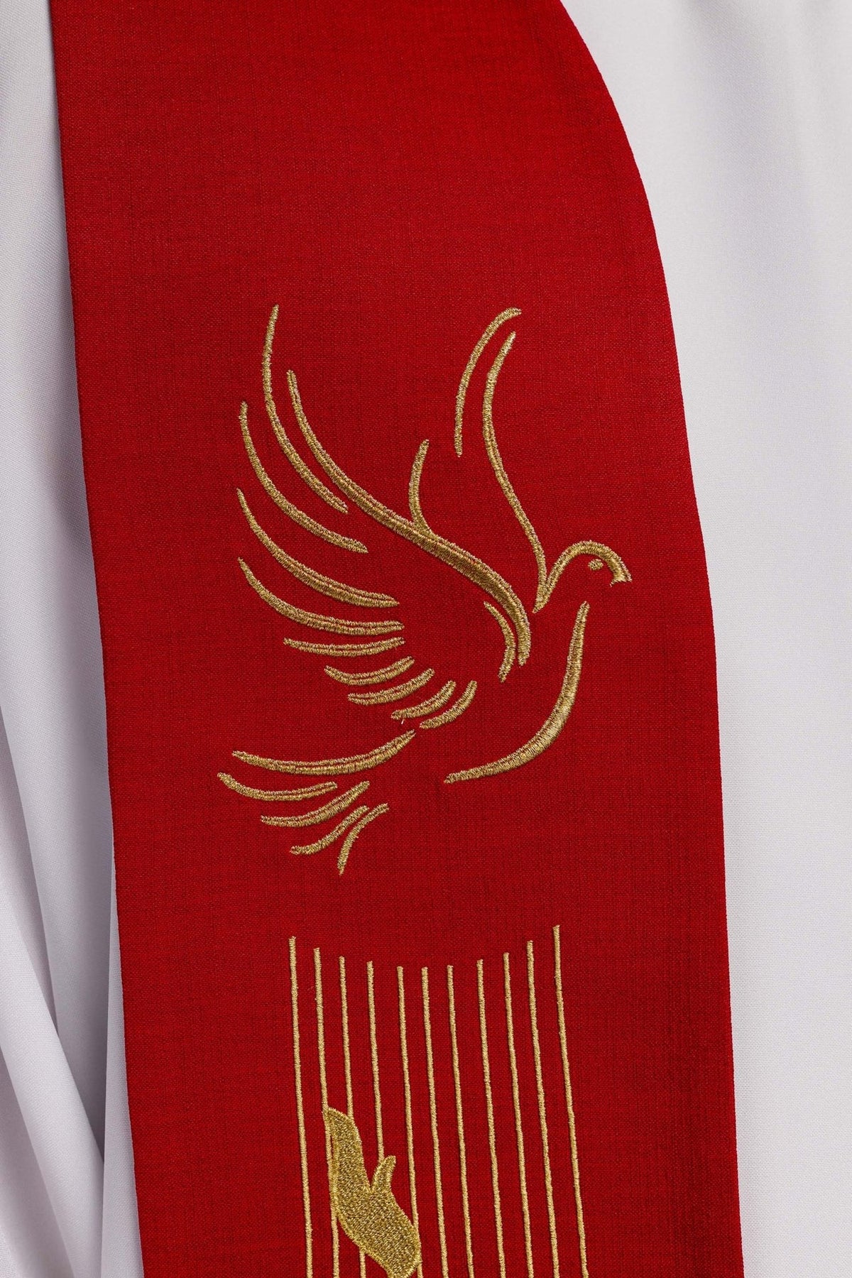 Red stole close-up with embroidered Holy Spirit dove and gold feather motifs
