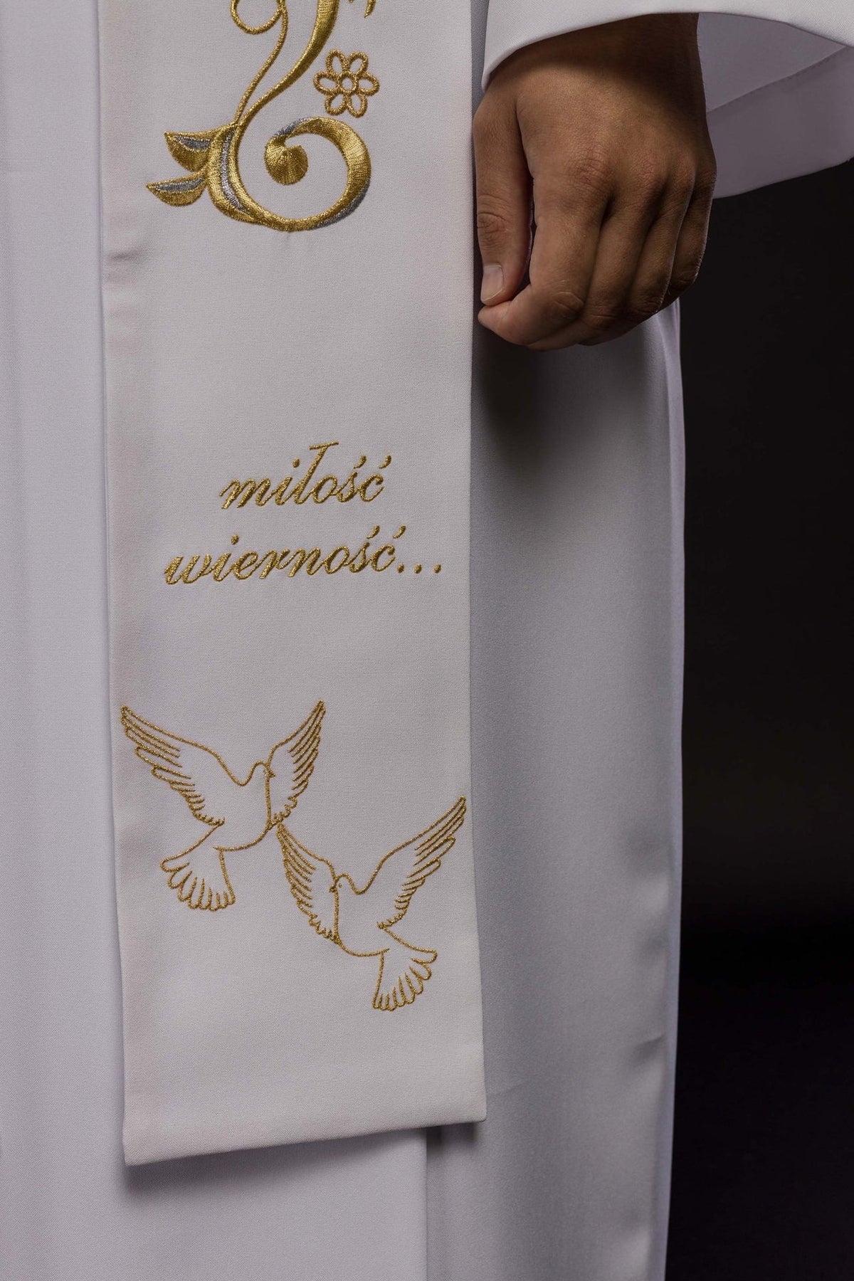 White wedding stole close-up showing gold text and wedding ring embroidery