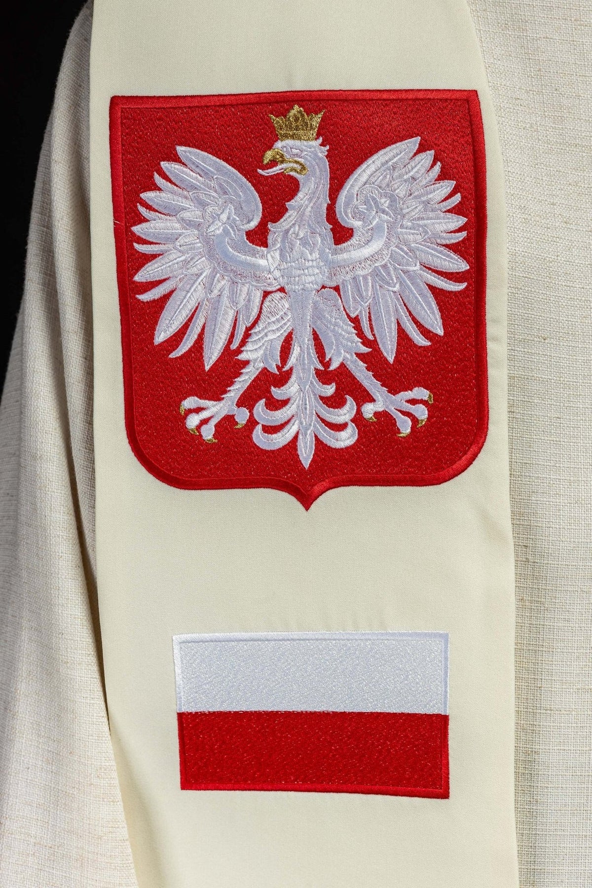 Embroidered stole close-up showing Polish eagle and red-and-white flag motifs