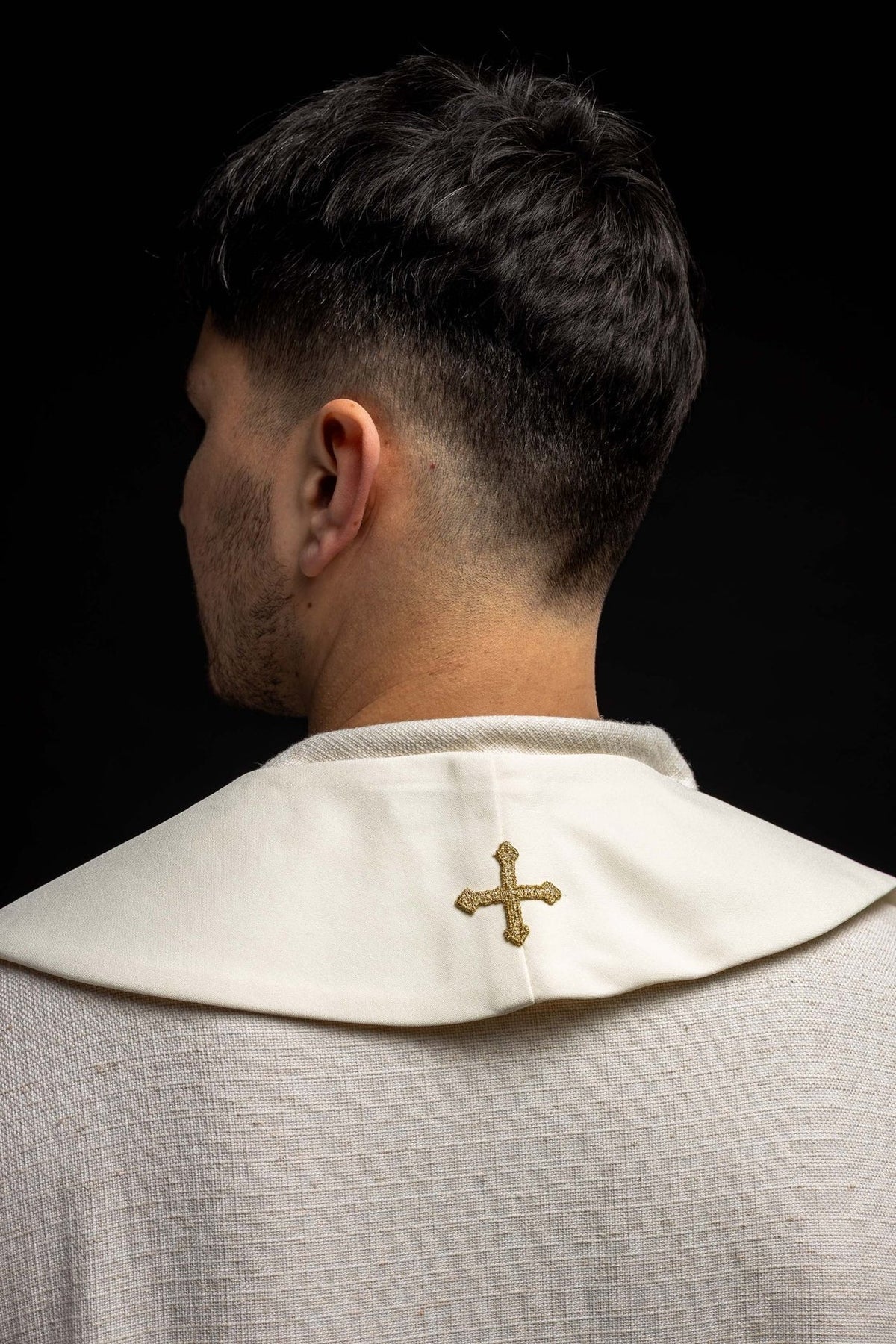 Embroidered stole back view with a small gold cross