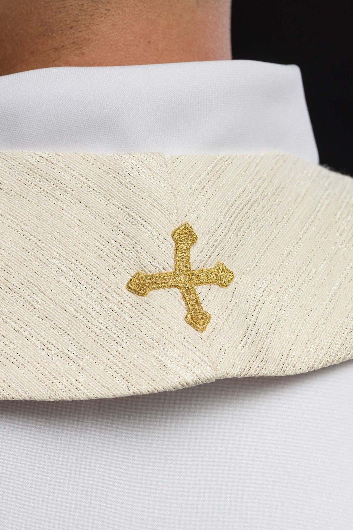 Ecru priest stole detail with gold embroidered cross at the neck