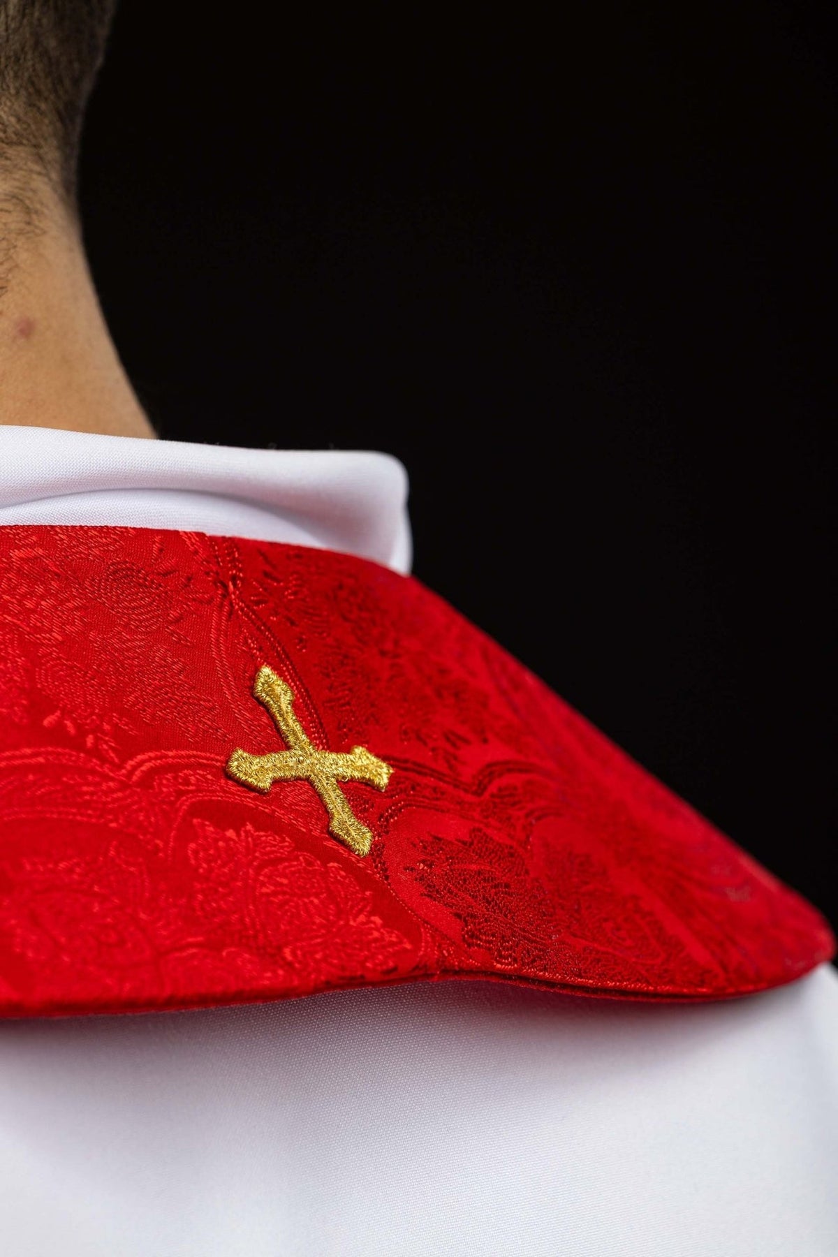 Red stole side close-up with gold embroidered cross