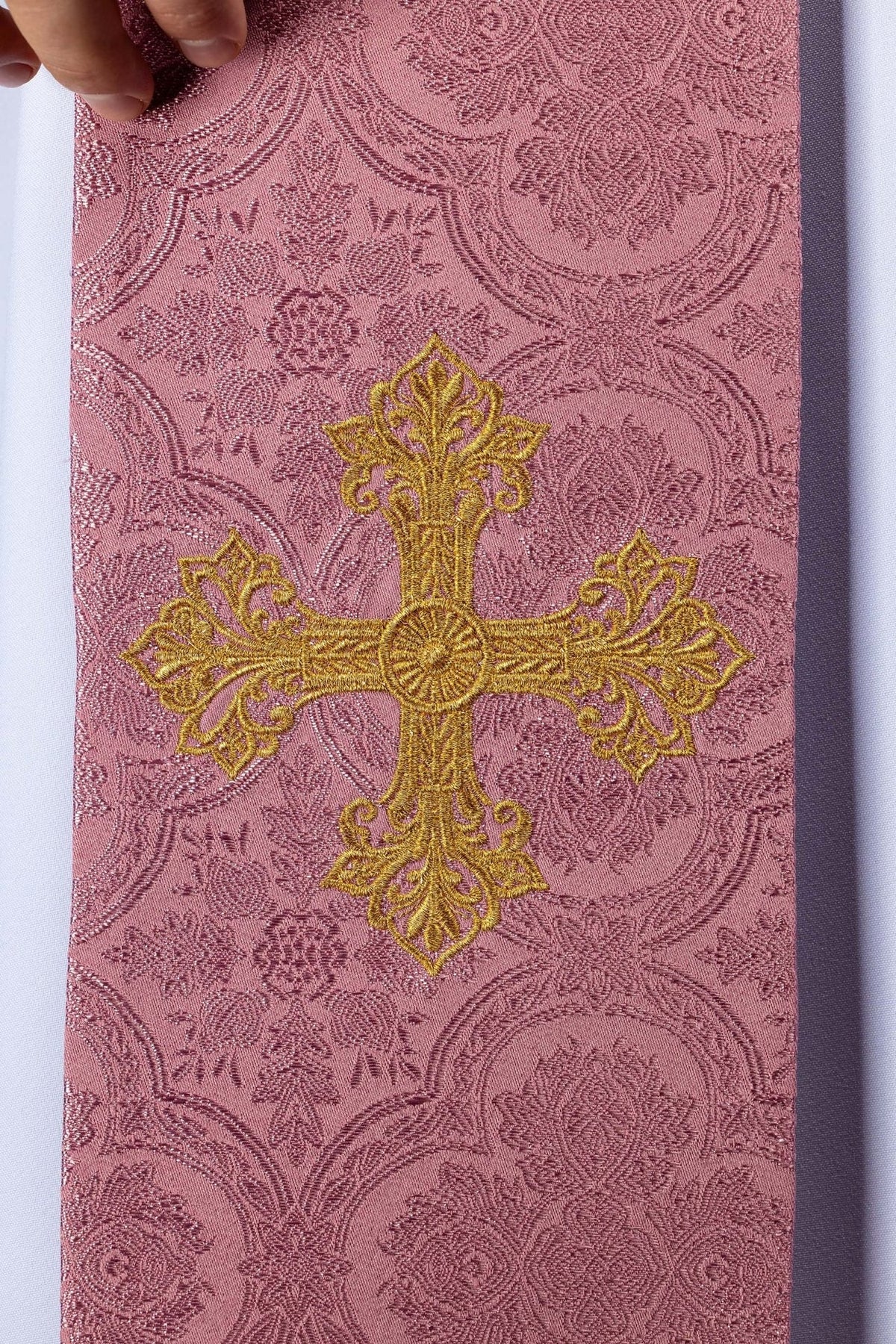 Rose priest stole detail with a large gold embroidered cross on floral jacquard