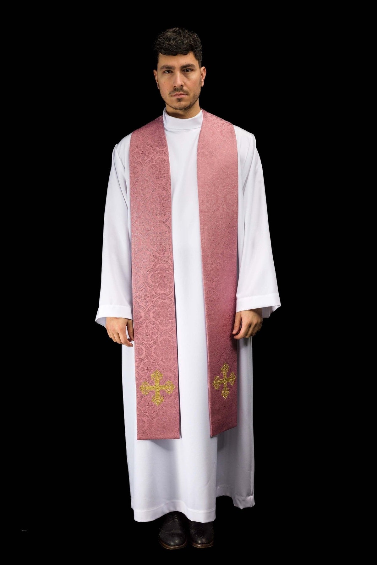 Rose stole worn front view, showing long panels, floral jacquard pattern and gold crosses