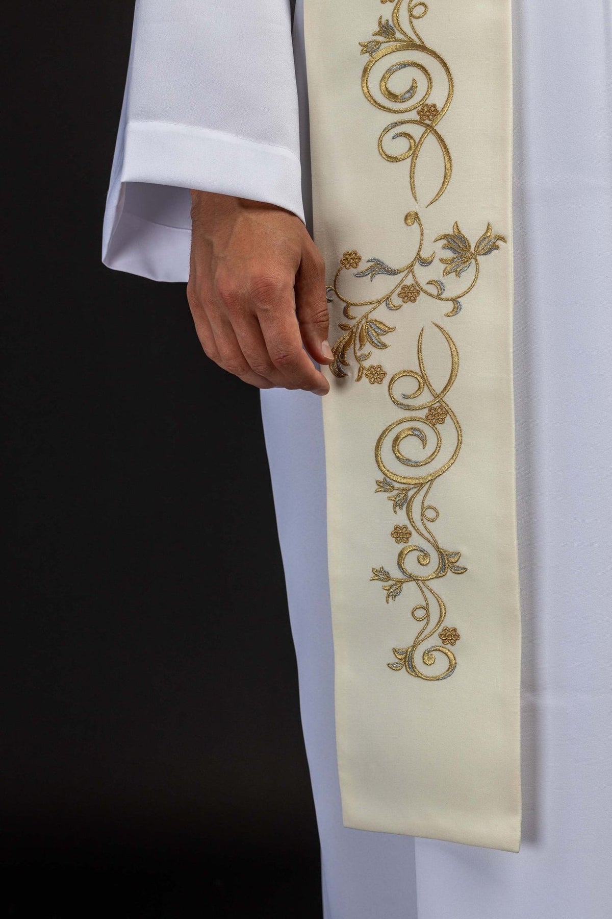 Ecru stole close-up showing ornate gold embroidery with floral and scrolling motifs