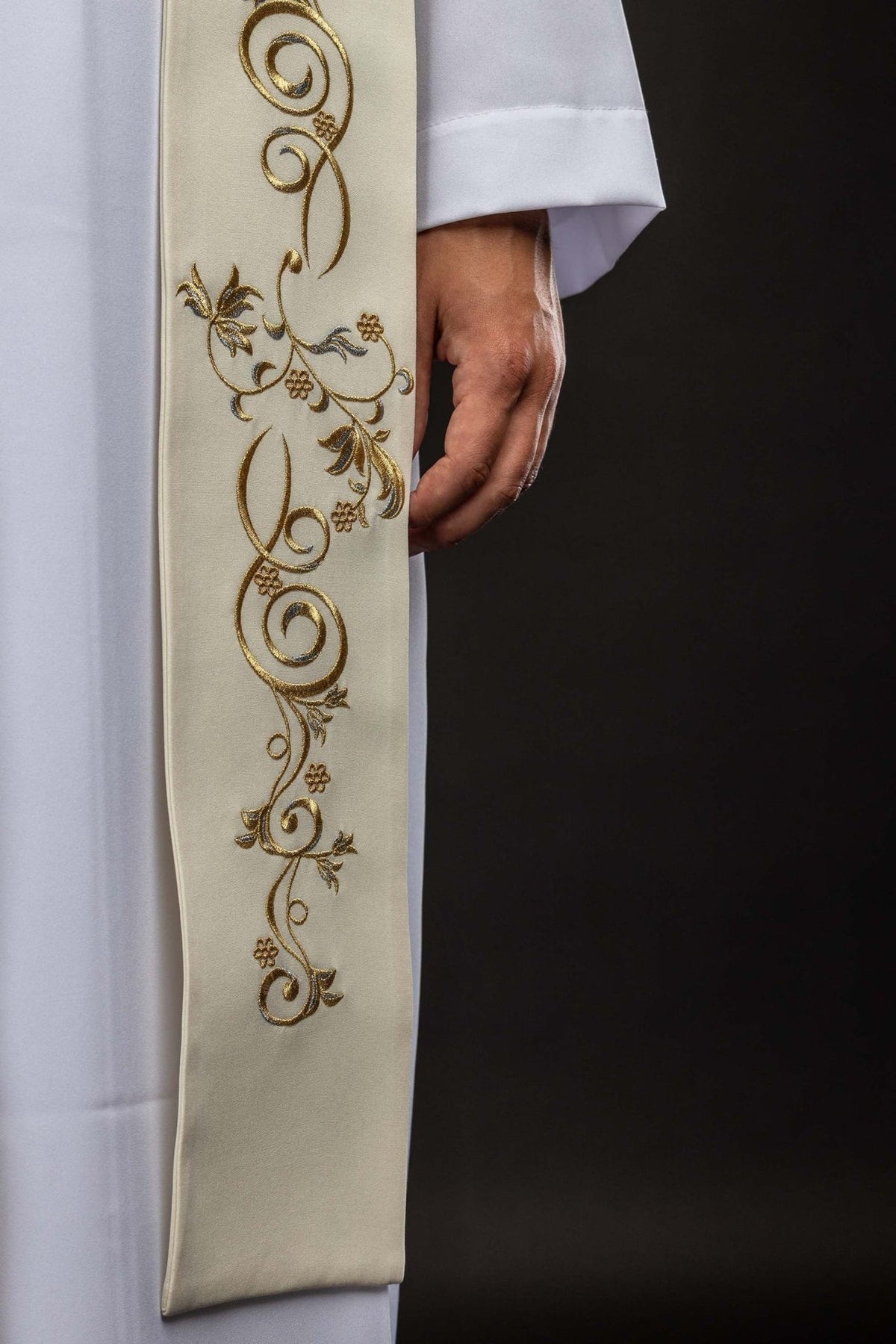 Ecru stole detail showing gold embroidered scrolling floral motifs