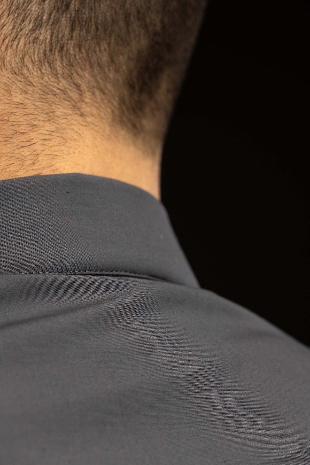 Clergy shirt close-up showing a front button and covered placket