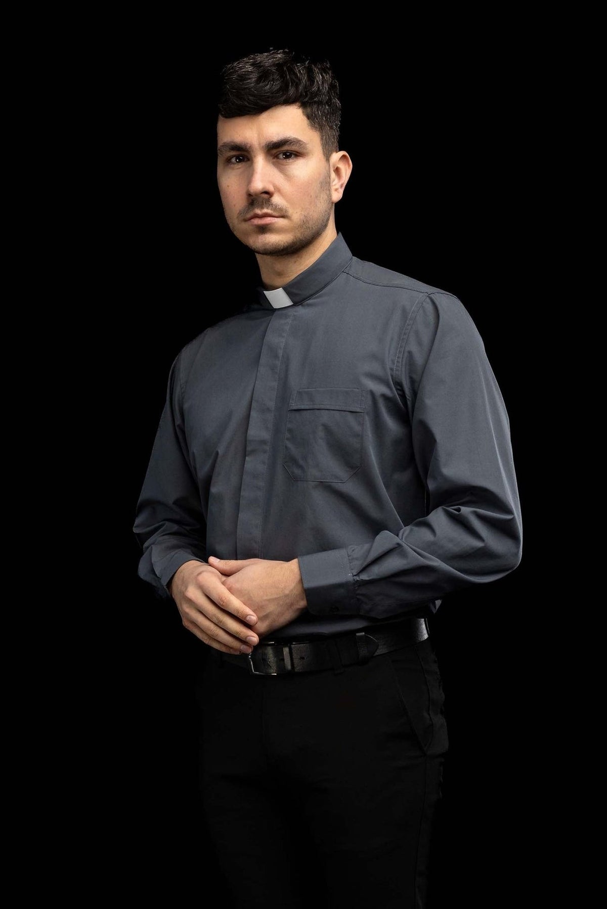 Dark gray clergy shirt worn from the back