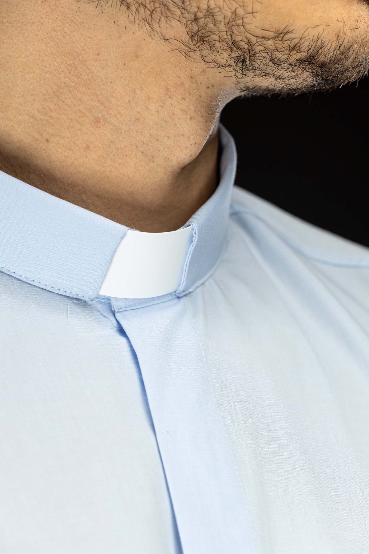 Light blue clergy shirt close-up of clerical collar from the side