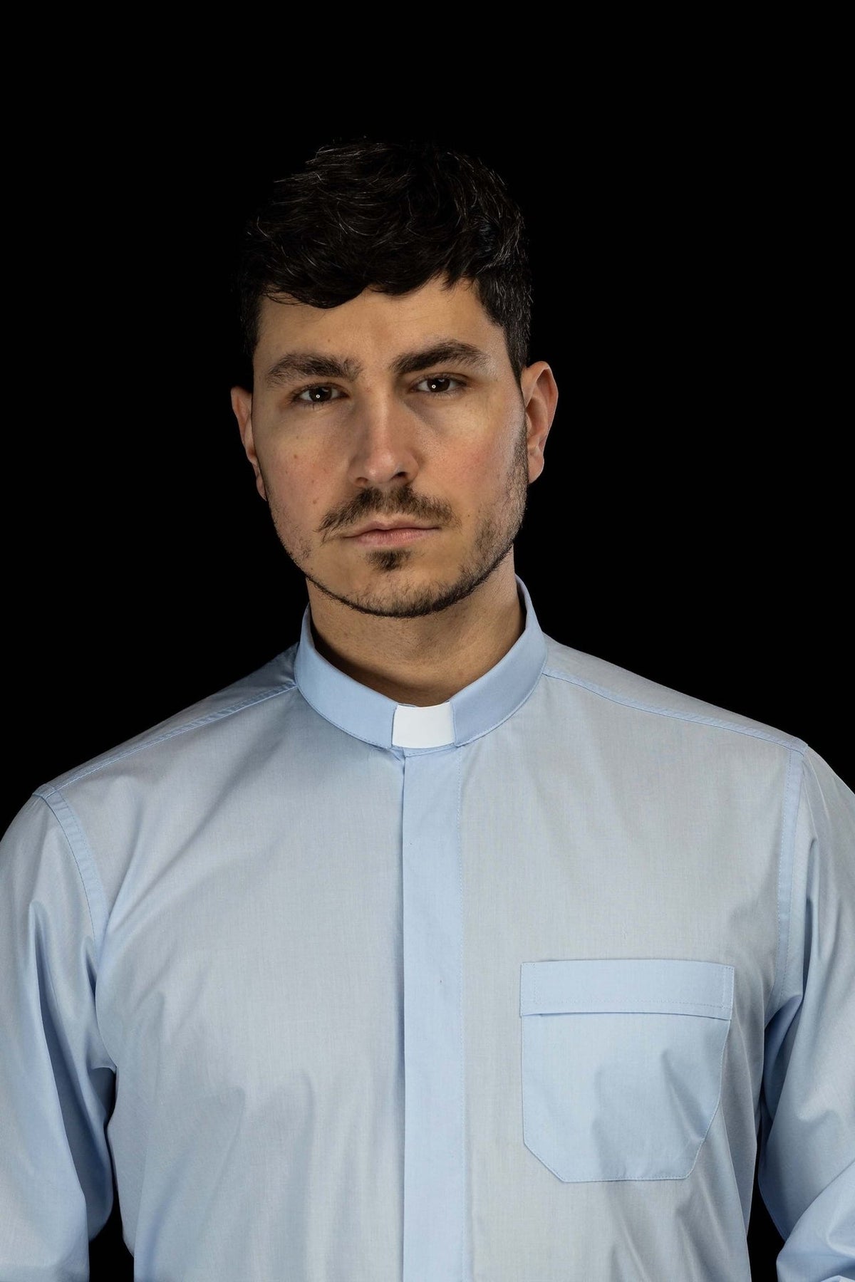Light blue clergy shirt front view with clerical collar and chest pocket