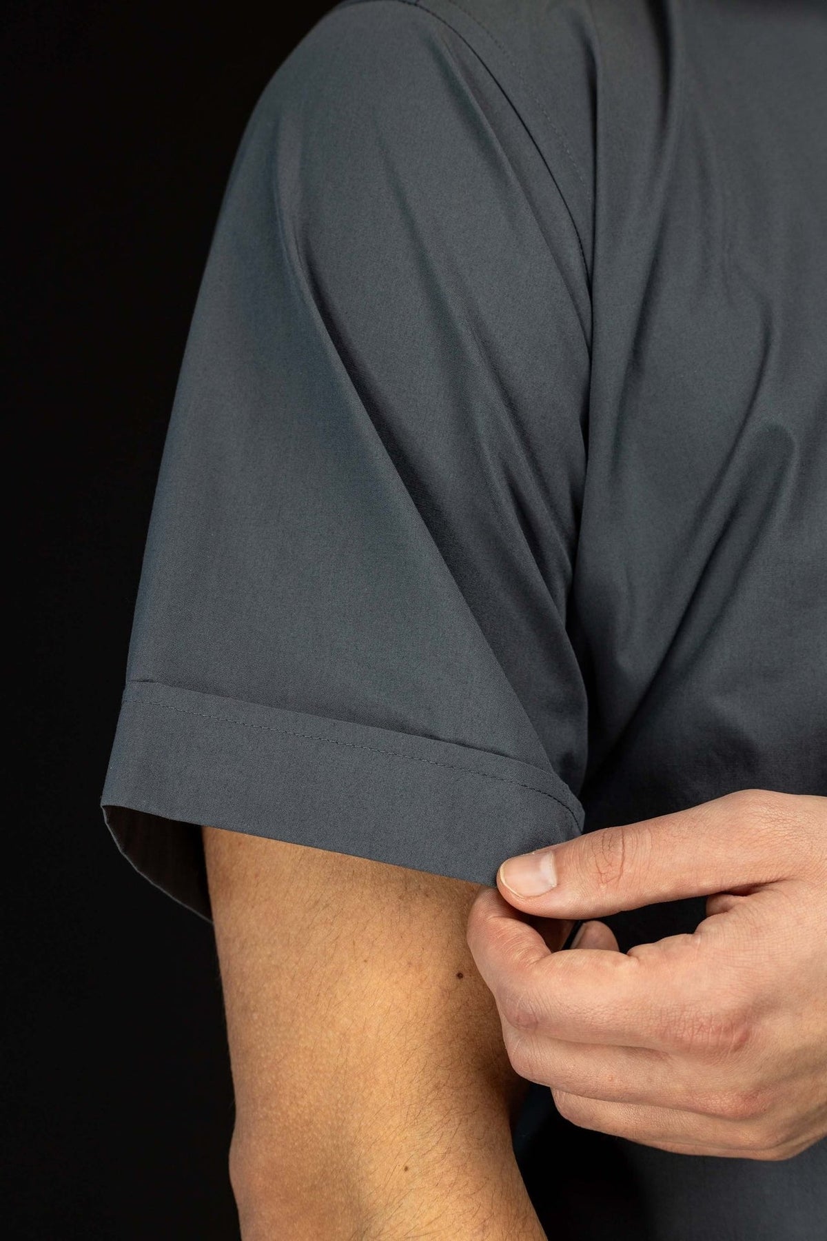 Dark gray clergy shirt close-up of short sleeve cuff