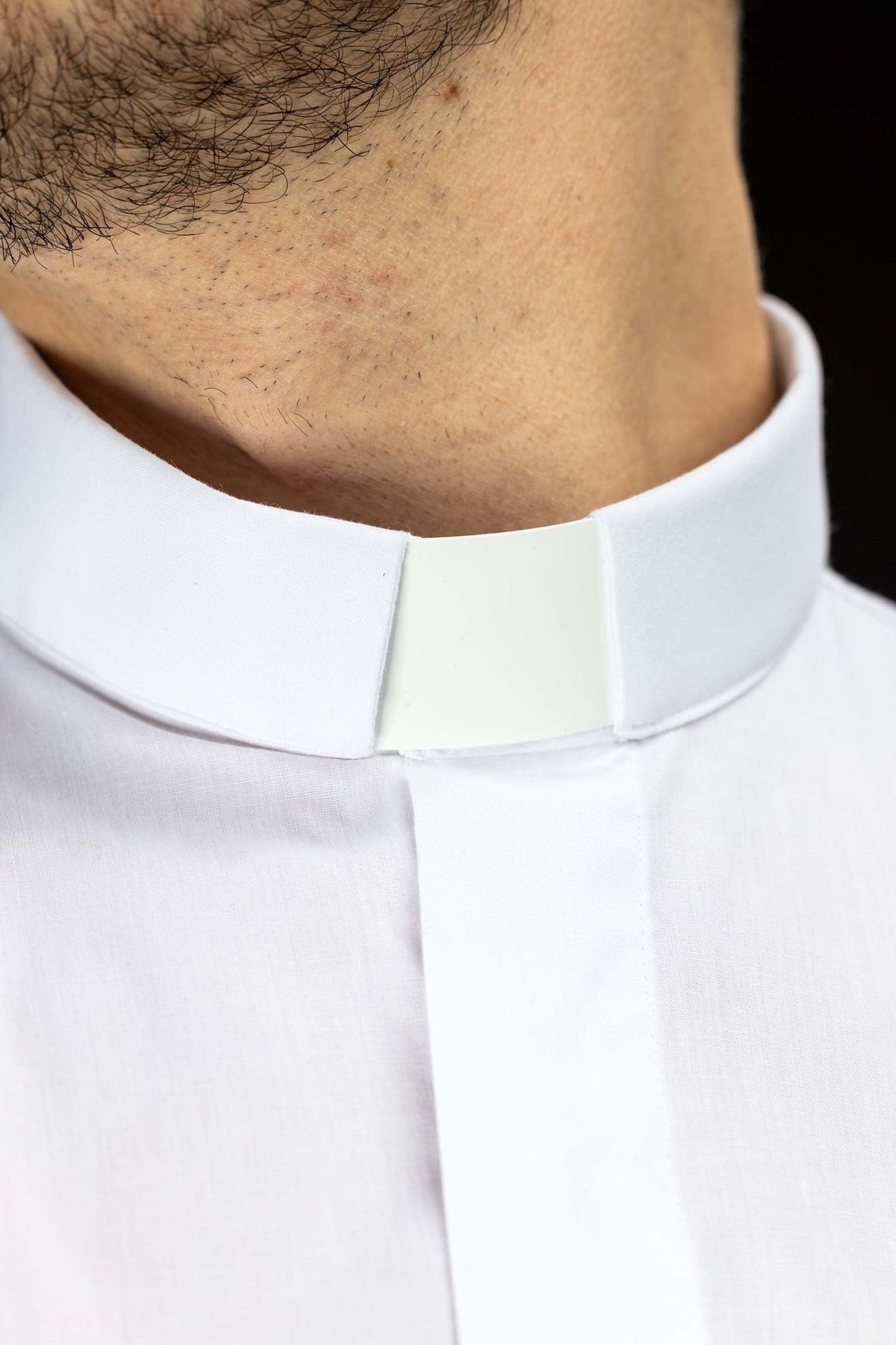 Clergy shirt close-up showing the white clerical collar and front placket