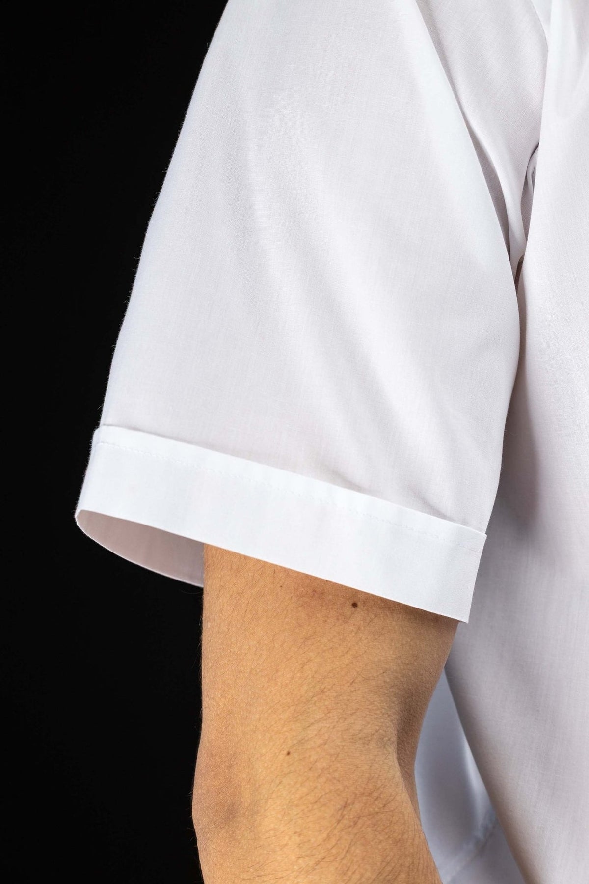 Clergy shirt close-up showing the white short sleeve with folded cuff