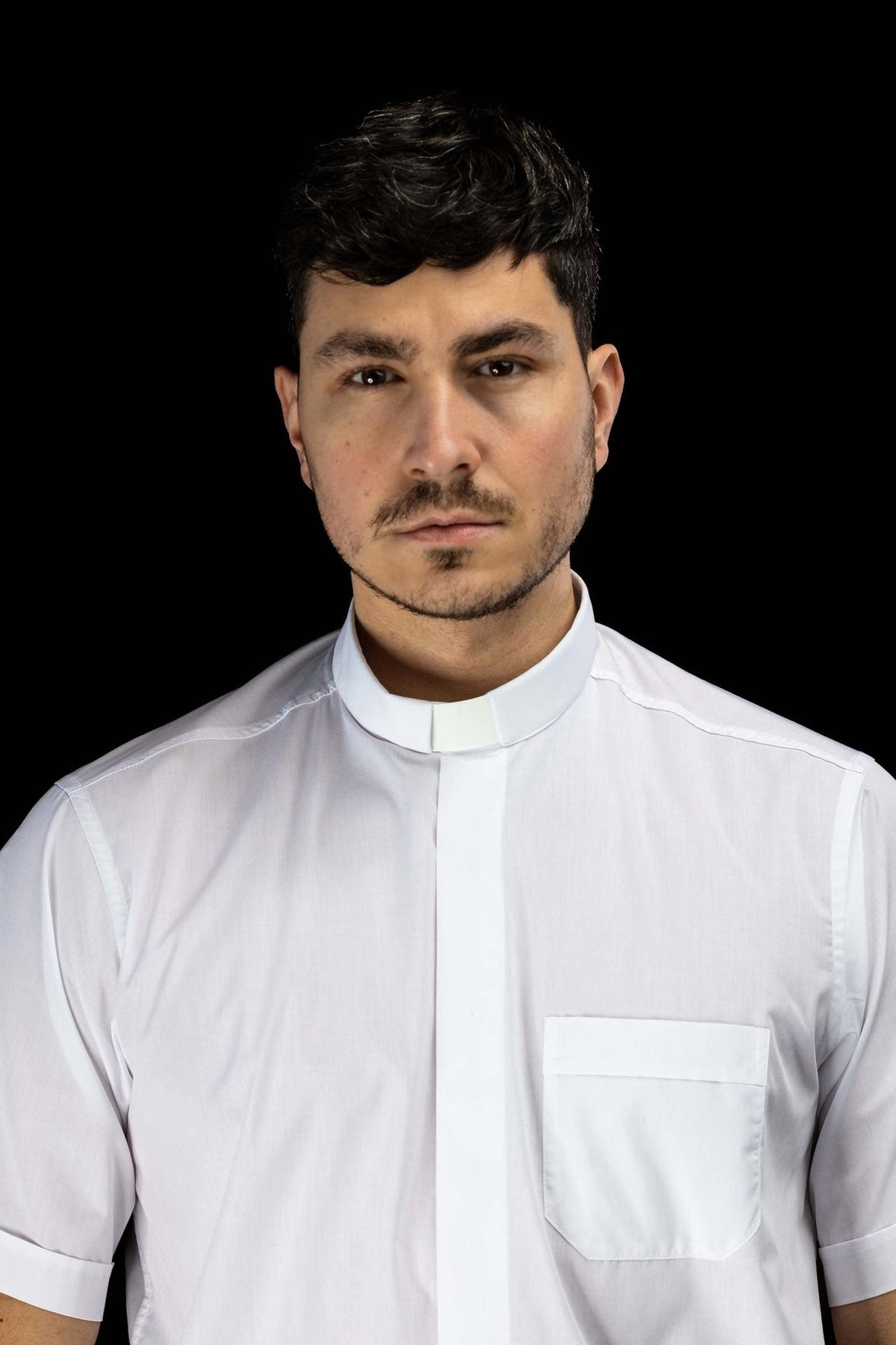 White clergy shirt front view showing the clerical collar, pocket and short sleeves
