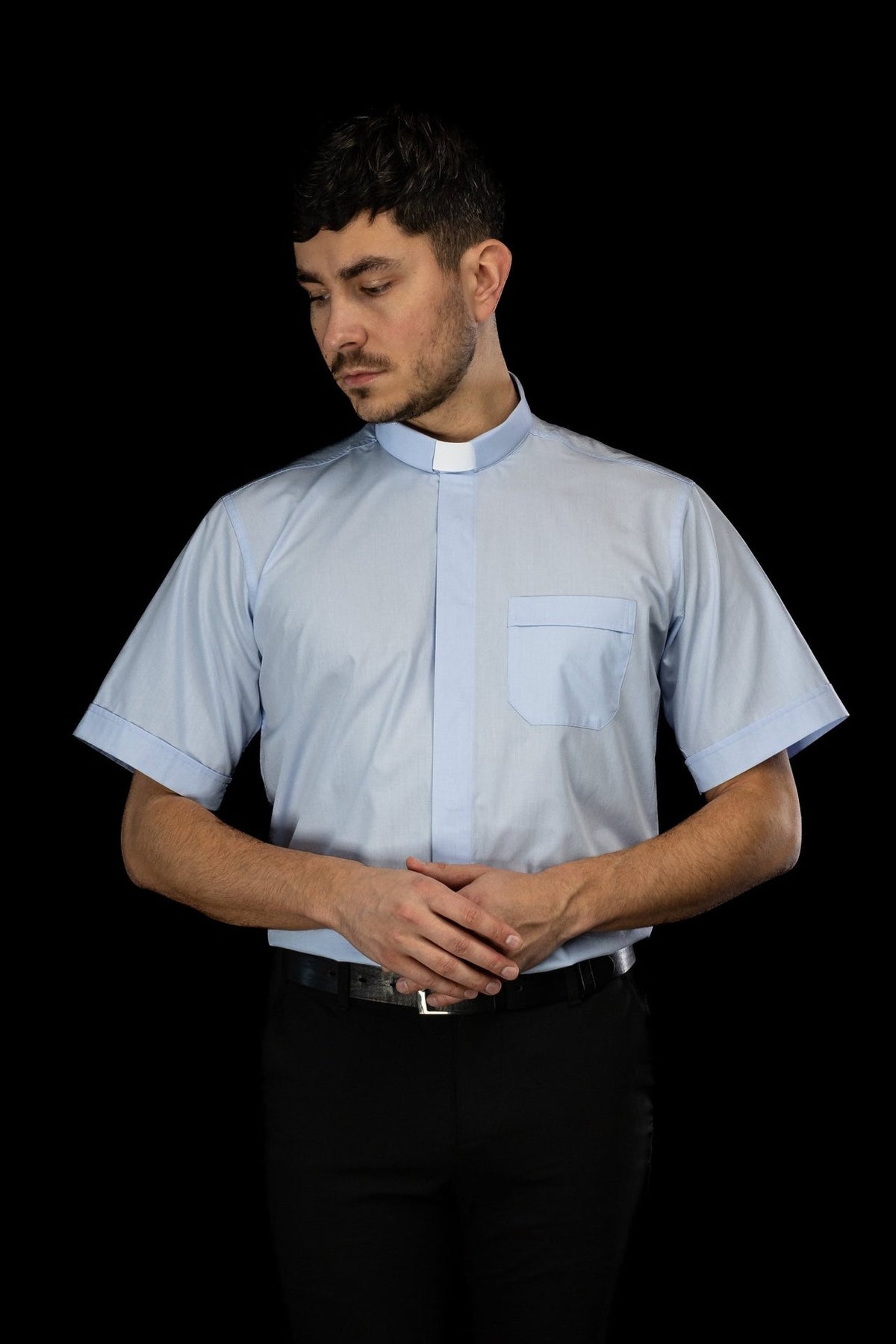 Light blue clergy shirt front view showing the clerical collar and pocket