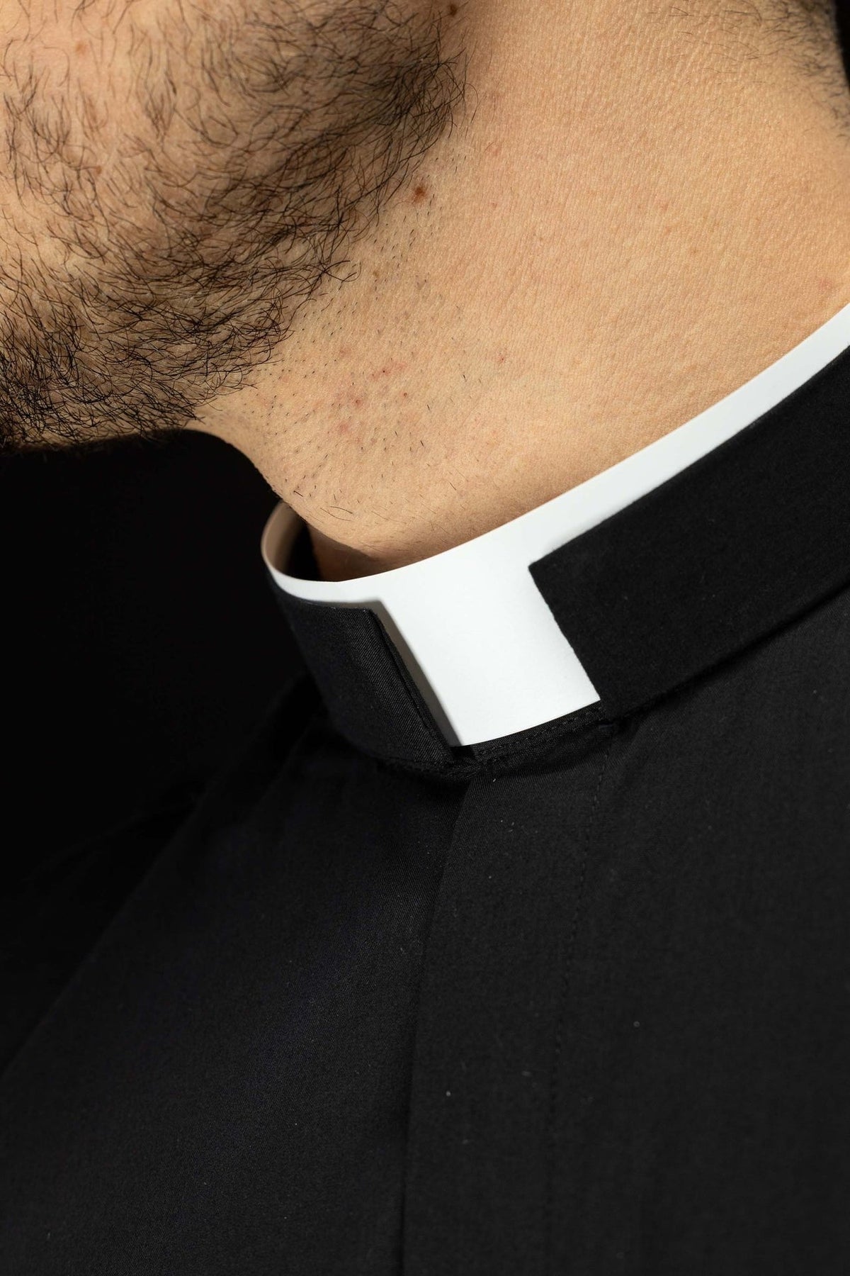 Clergy shirt close-up showing the white clerical collar and black fabric