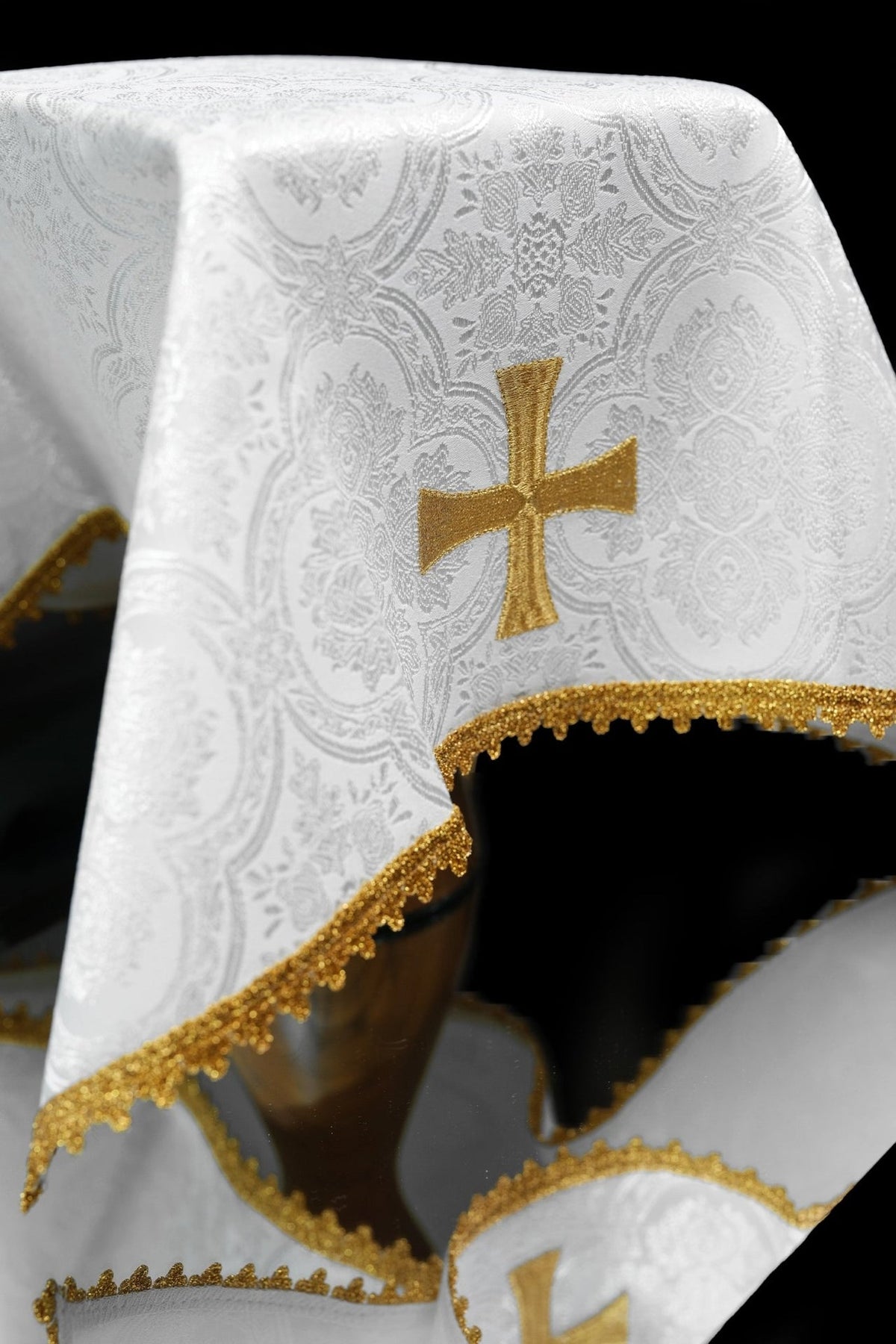 White jacquard chalice veil close-up with gold embroidered cross and trim
