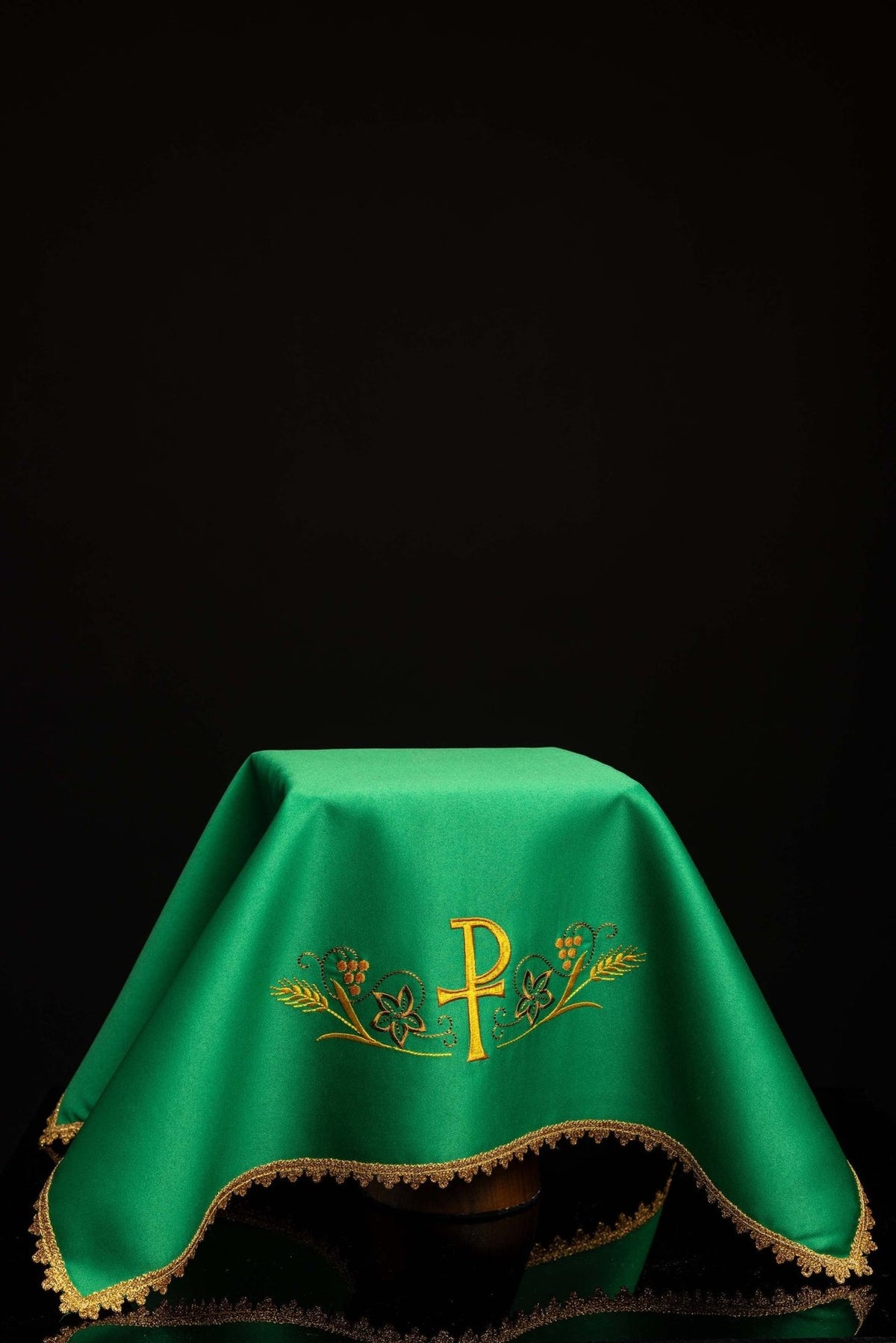 Green chalice veil with PAX embroidery and gold trim, draped view