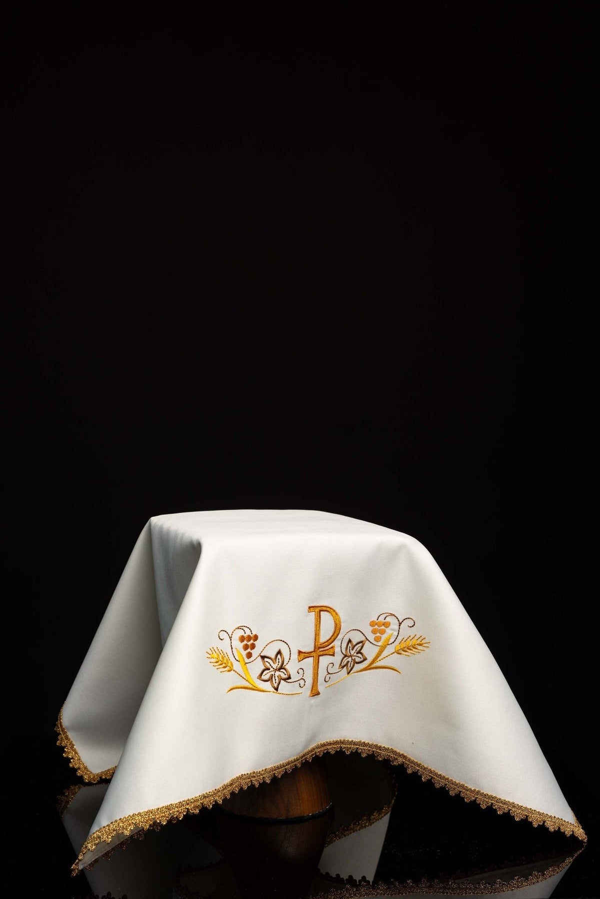 White chalice veil with PAX embroidery and gold trim, draped view