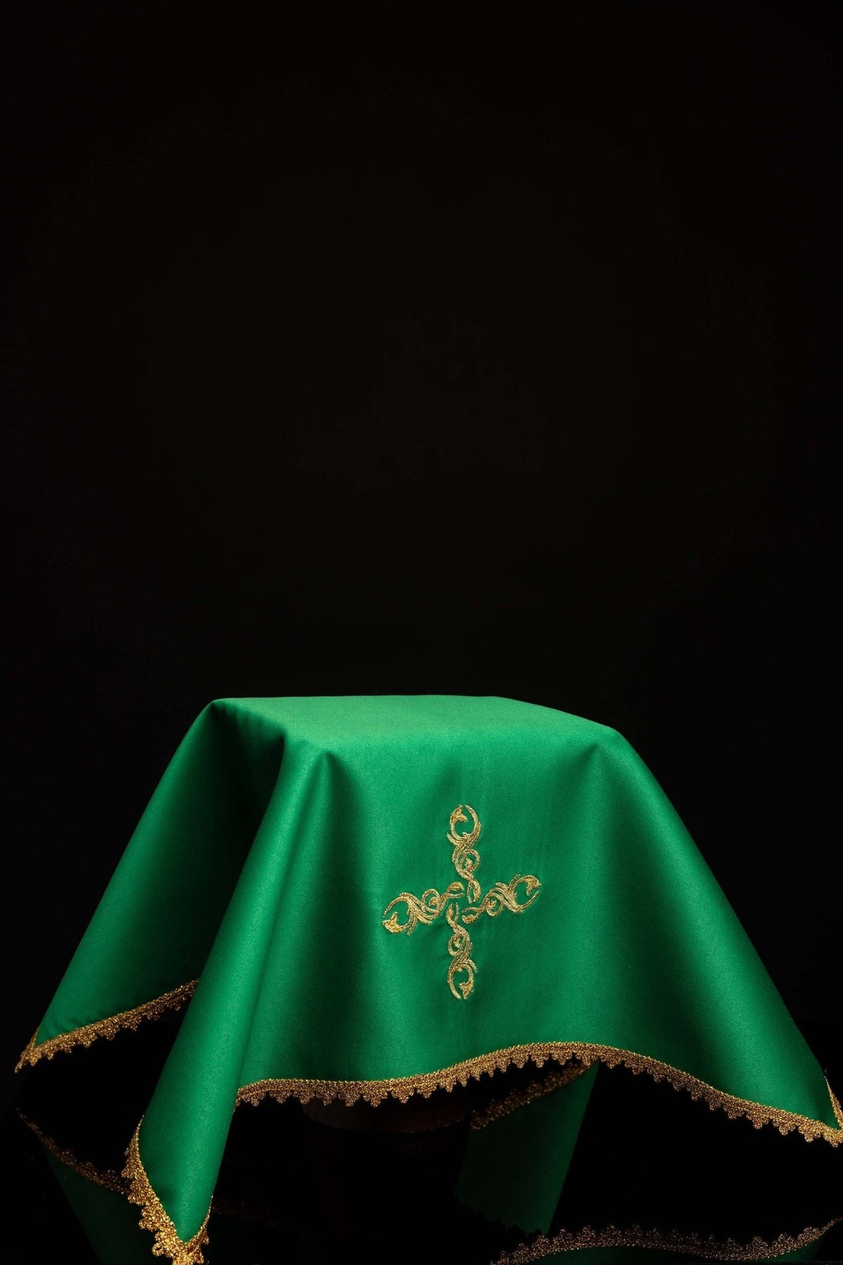 Green chalice veil worn, with gold embroidered cross and gold trim
