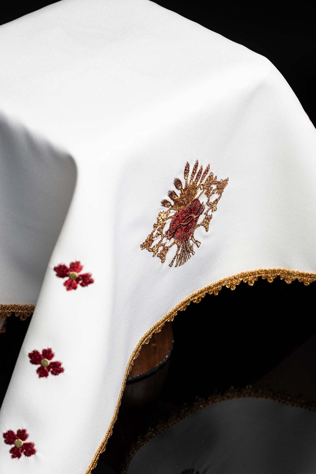 White chalice veil close-up with Sacred Heart of Jesus embroidery and gold edging