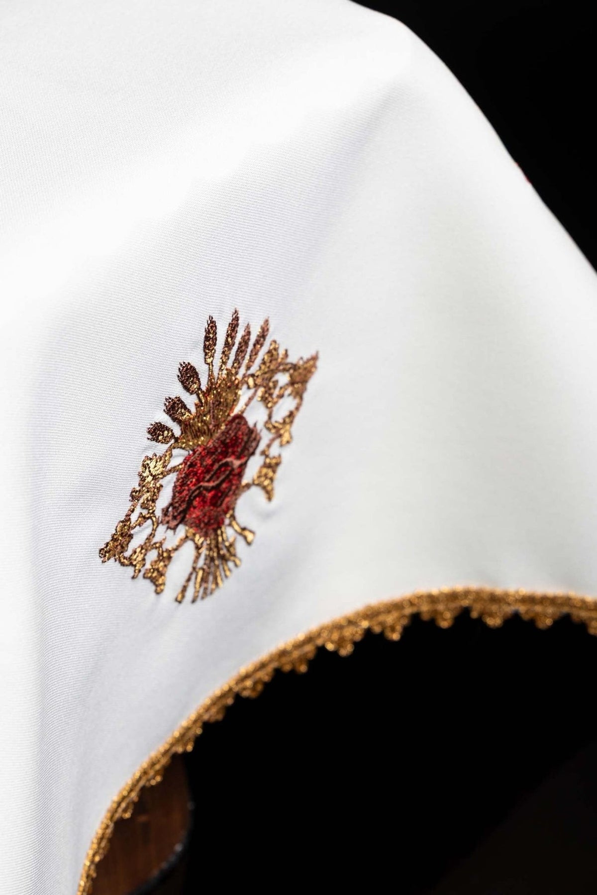 White chalice veil detail showing Sacred Heart of Jesus embroidery and gold trim