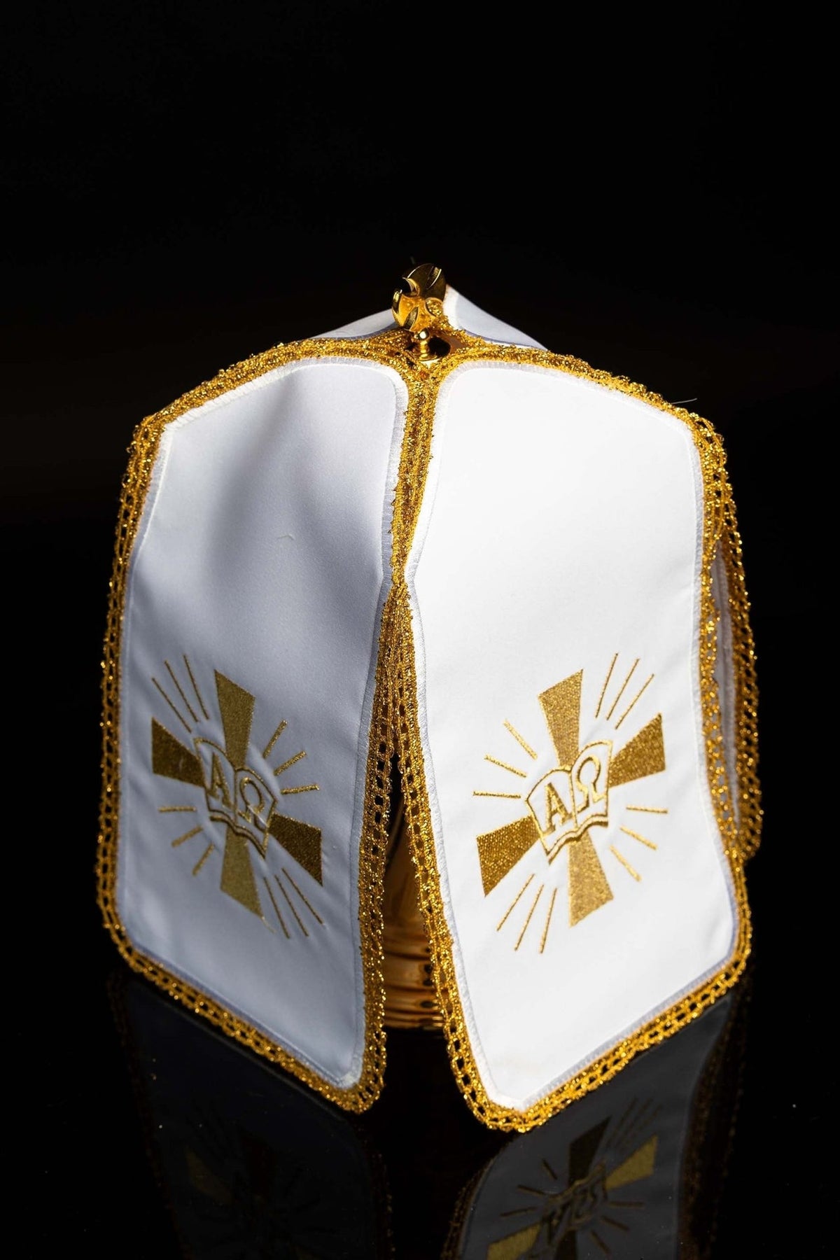 Ciborium veil front view showing white panels, gold Alpha Omega embroidery and cross-shaped rays