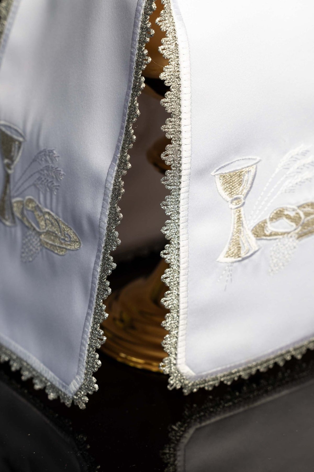 Ciborium veil close-up showing silver embroidered trim and Eucharistic motifs