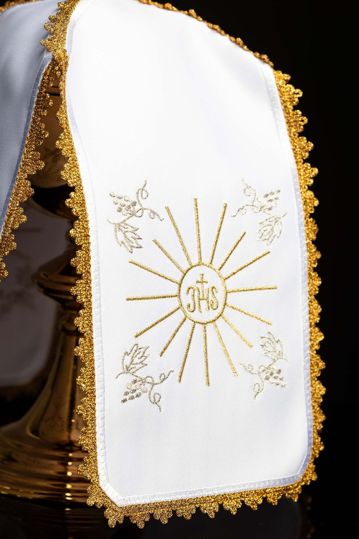 Ciborium veil close-up showing IHS monogram, gold rays, floral embroidery and gold trim