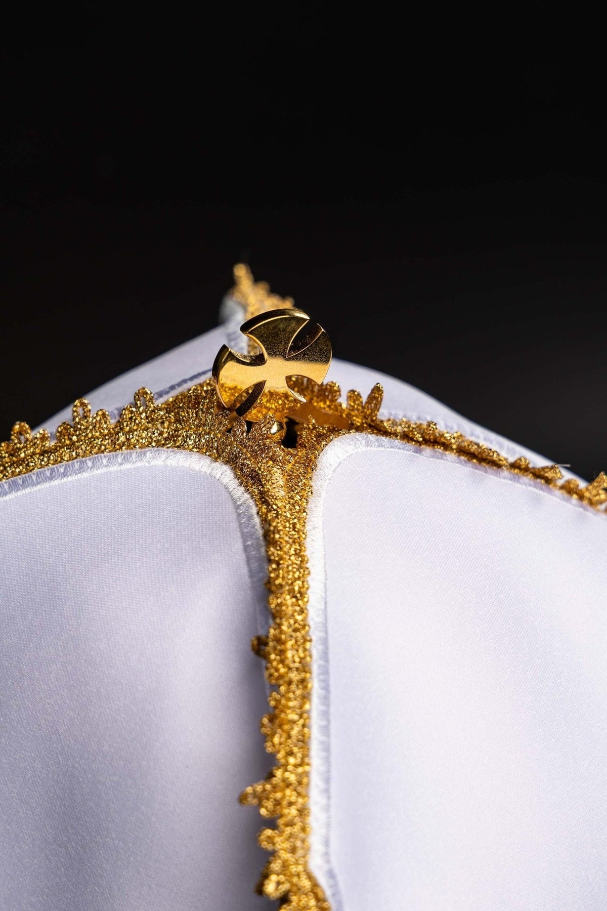 White ciborium veil close-up of gold trim and cross clasp