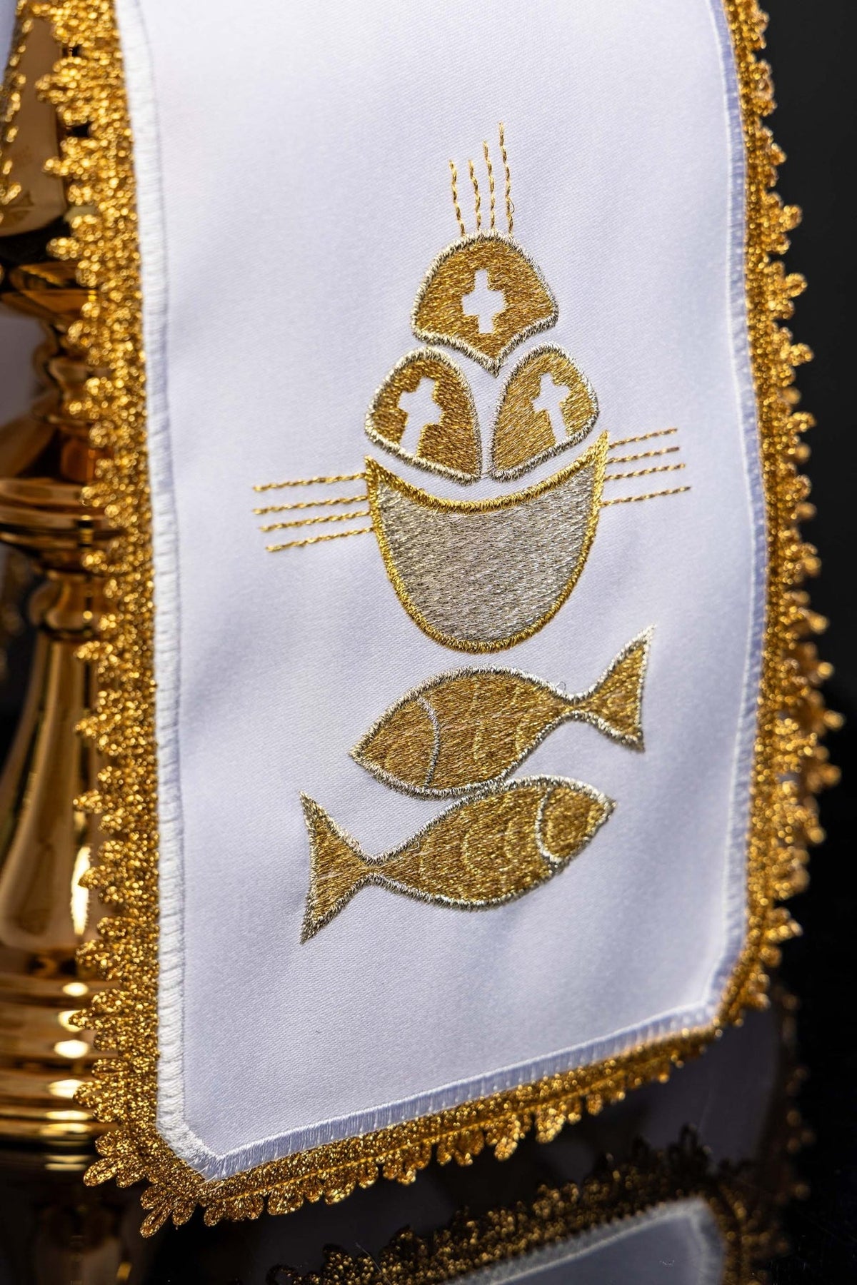 White ciborium veil close-up of gold embroidery showing bread and fish