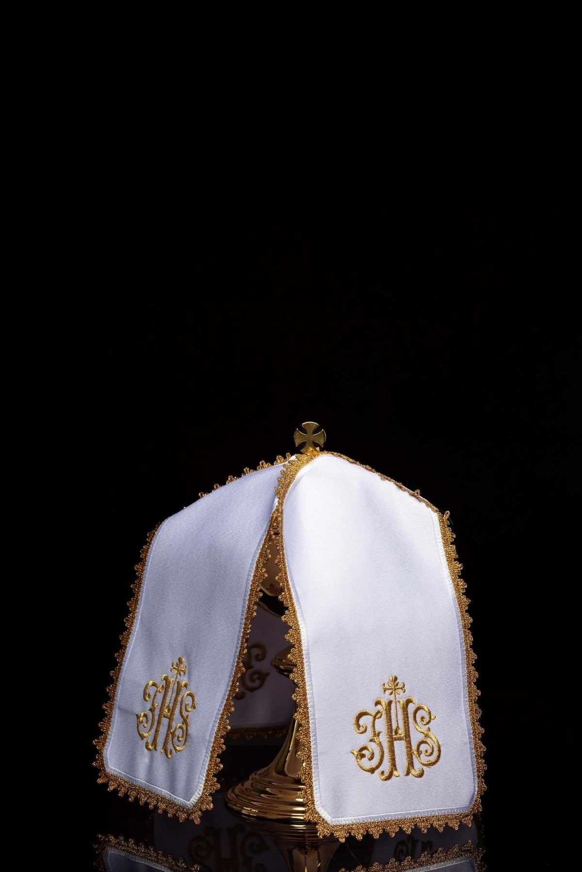 Ciborium veil, angled view showing white panels and gold IHS embroidery