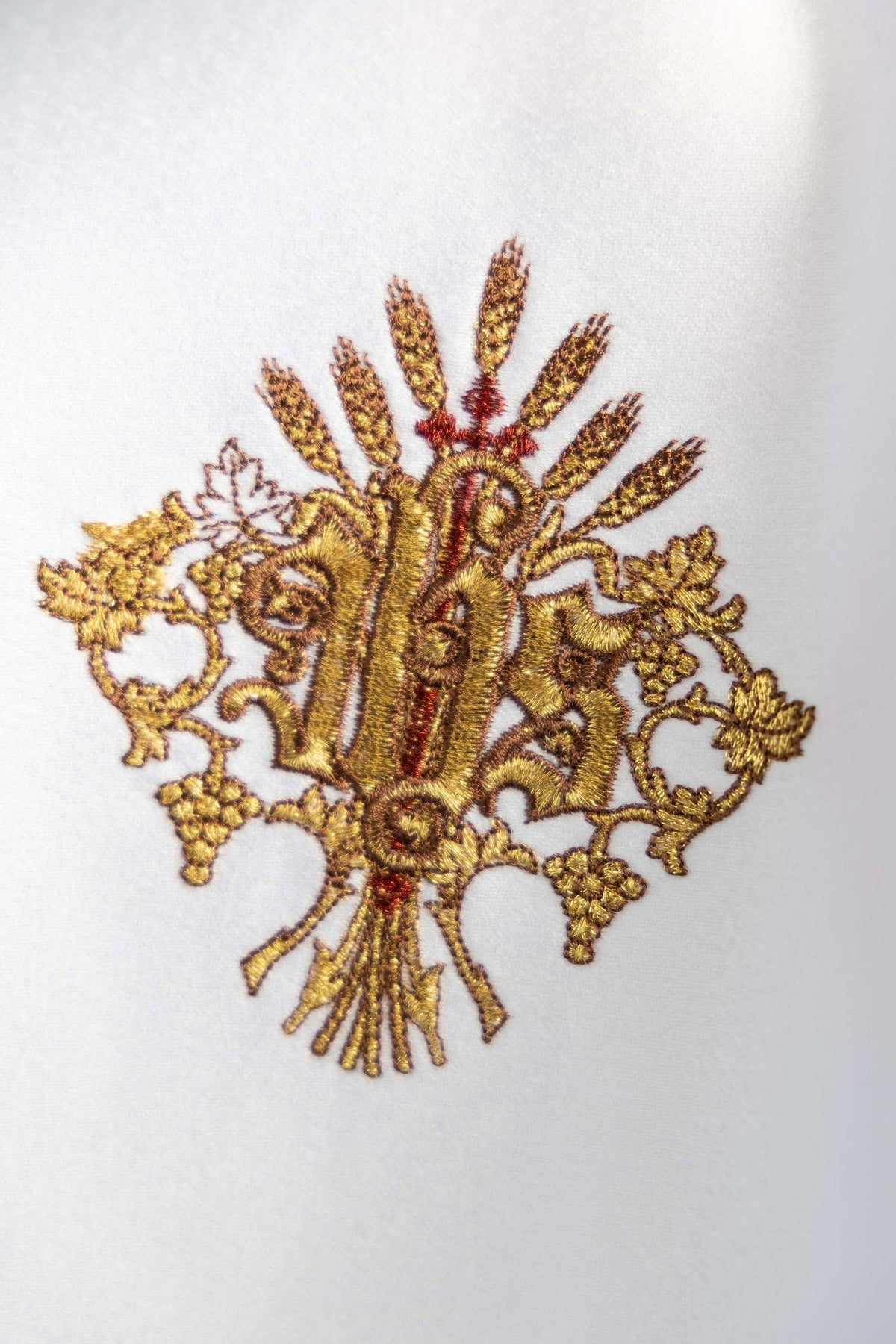 Ciborium veil close-up of gold IHS embroidery on white fabric