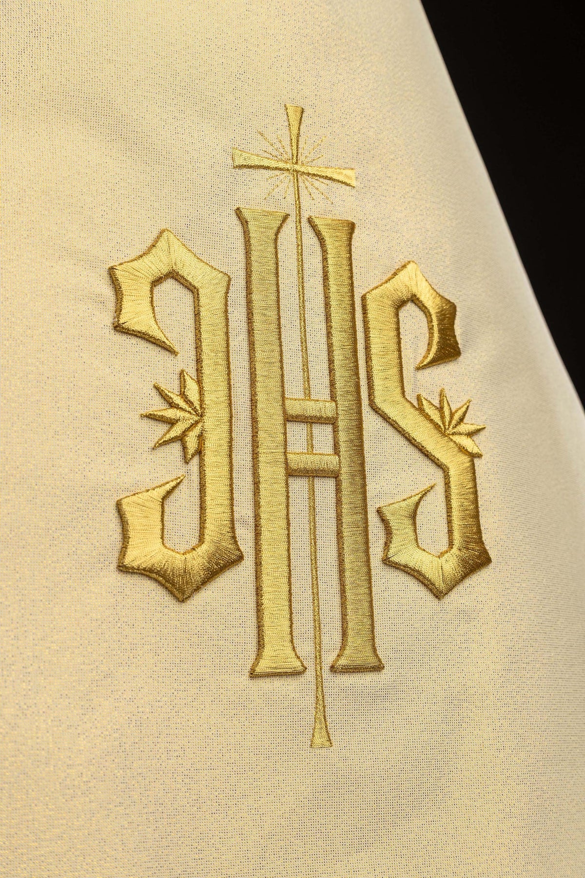Humeral veil close-up of gold embroidered IHS symbol with cross
