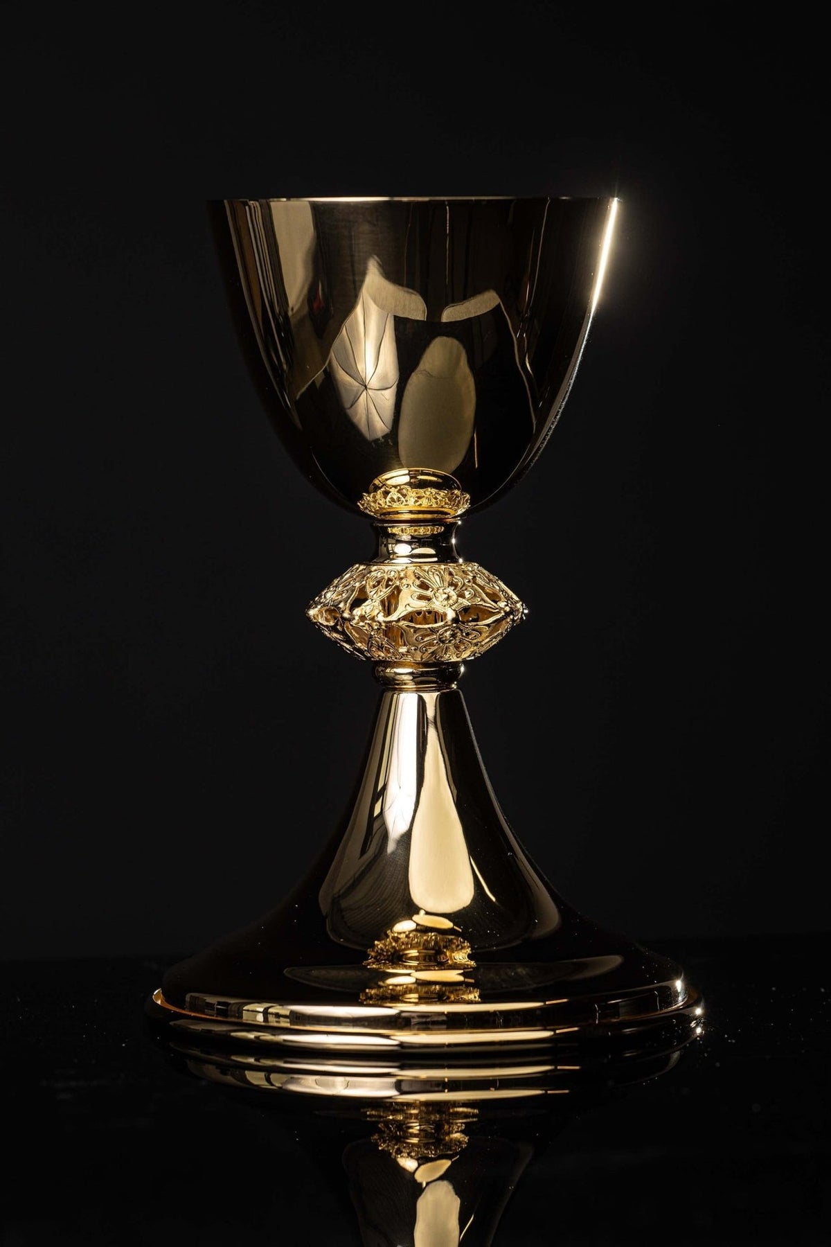 Gold-plated brass chalice full front view with ornate stem and broad base