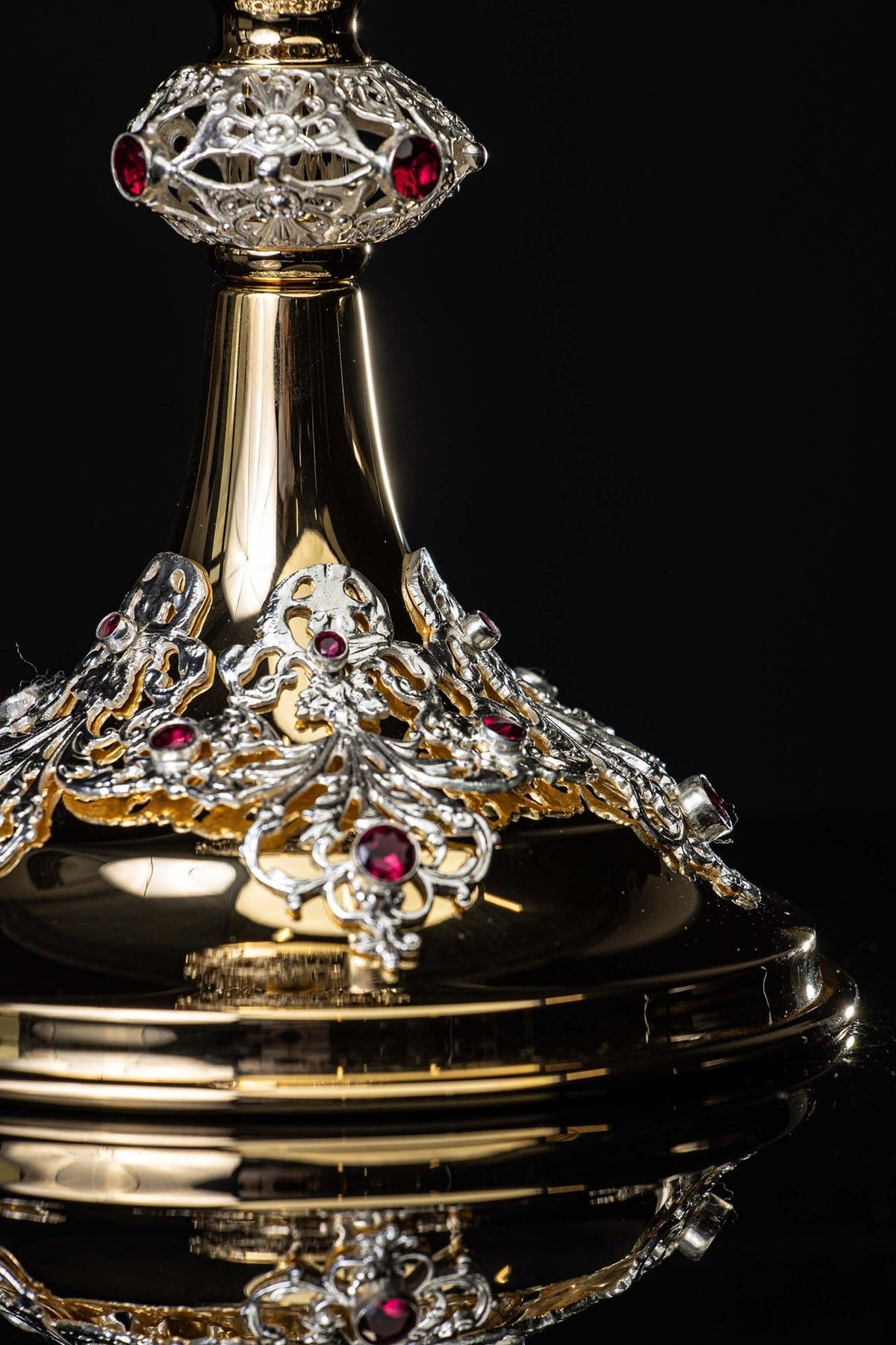 Gold-plated chalice close-up of ornate stem and ruby-studded base details