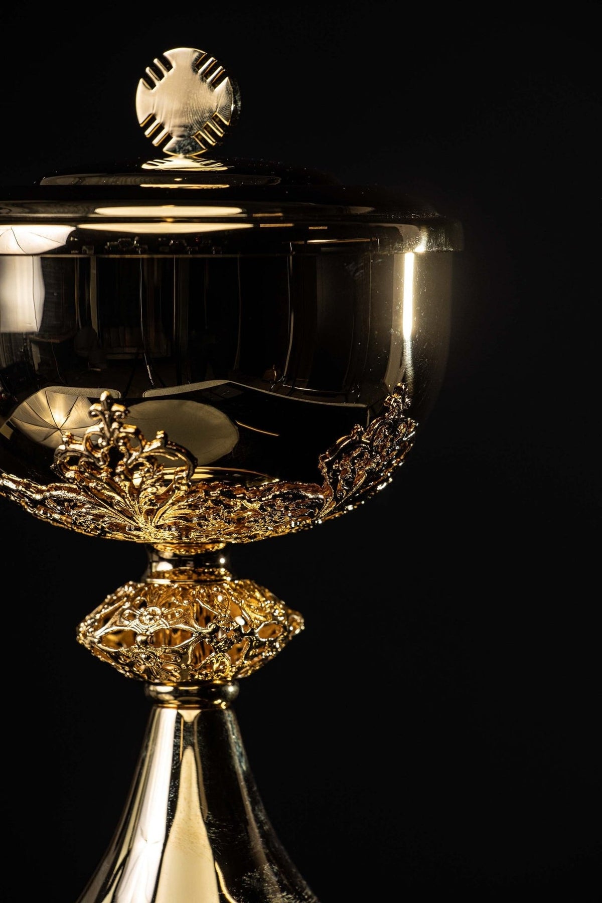 Gold-plated brass ciborium side view showing the lid, ornate bowl, and openwork stem