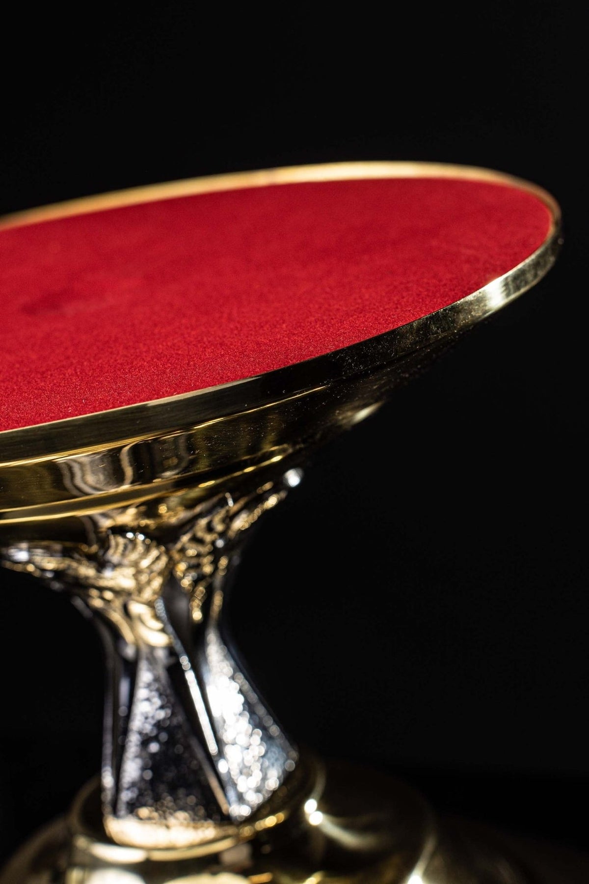 Thabor table side close-up showing red top and angel motif