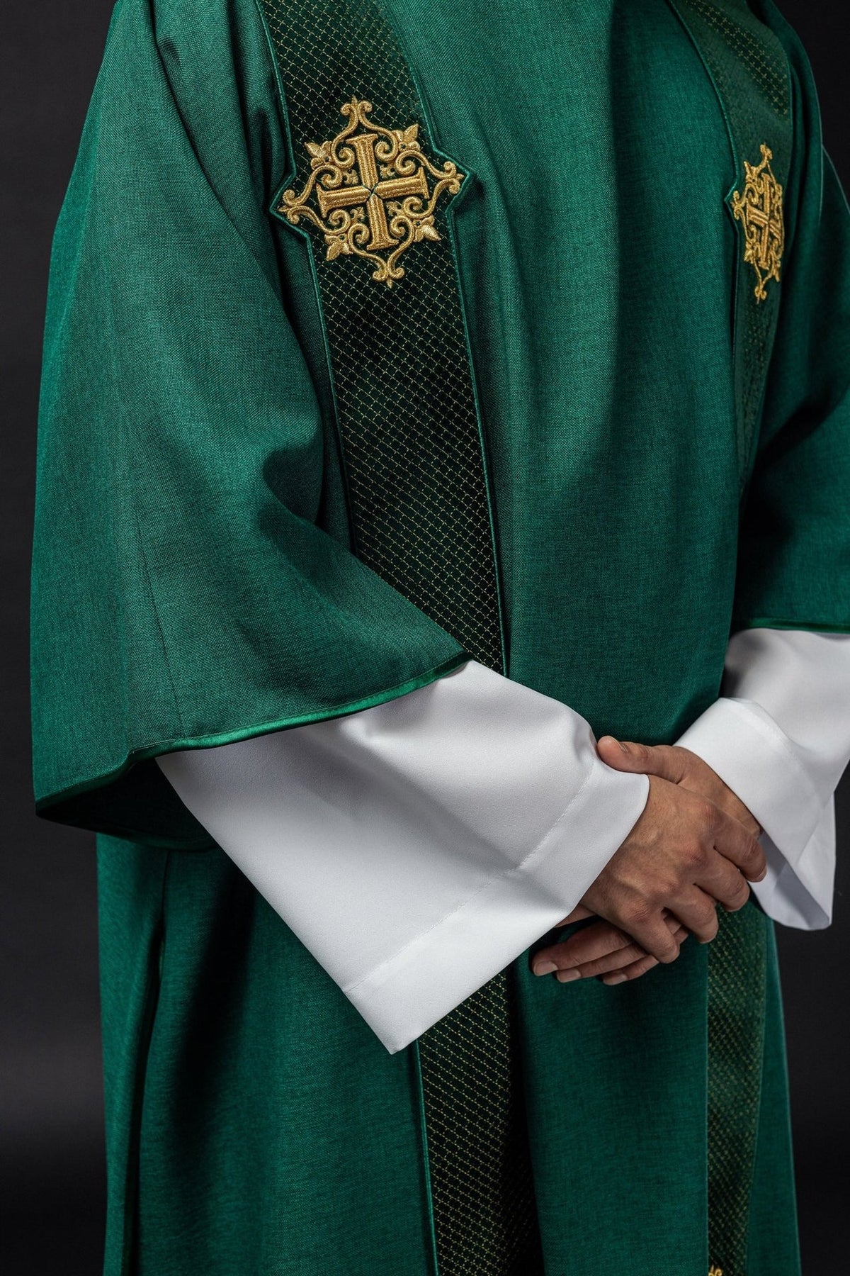 Green velvet dalmatic, side front view showing embroidered cross and wide sleeves