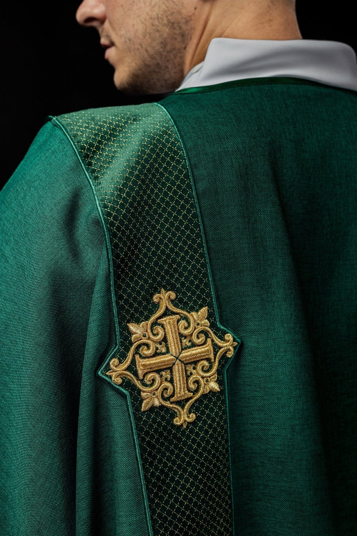 Green velvet dalmatic, close-up back view of embroidered cross on orphrey