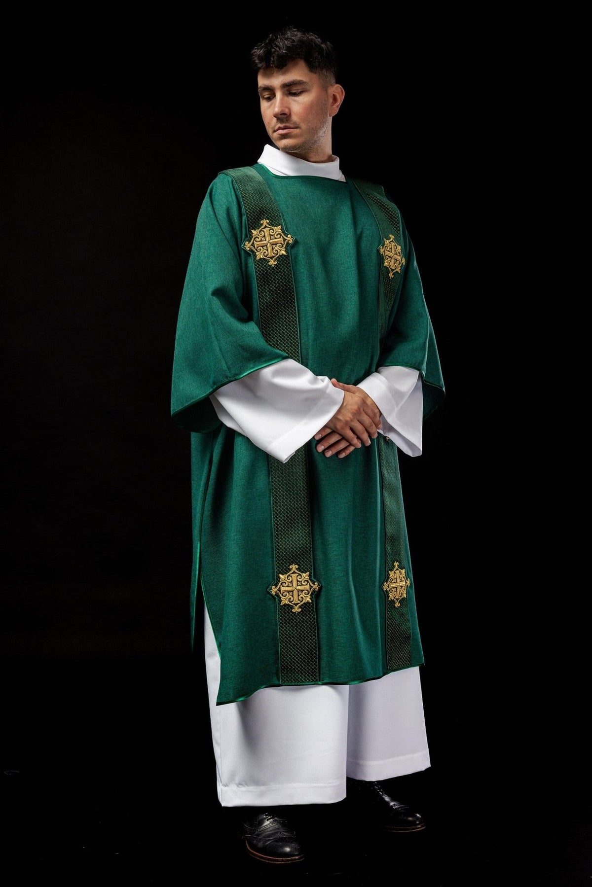Green velvet dalmatic, angled front view with gold embroidered crosses