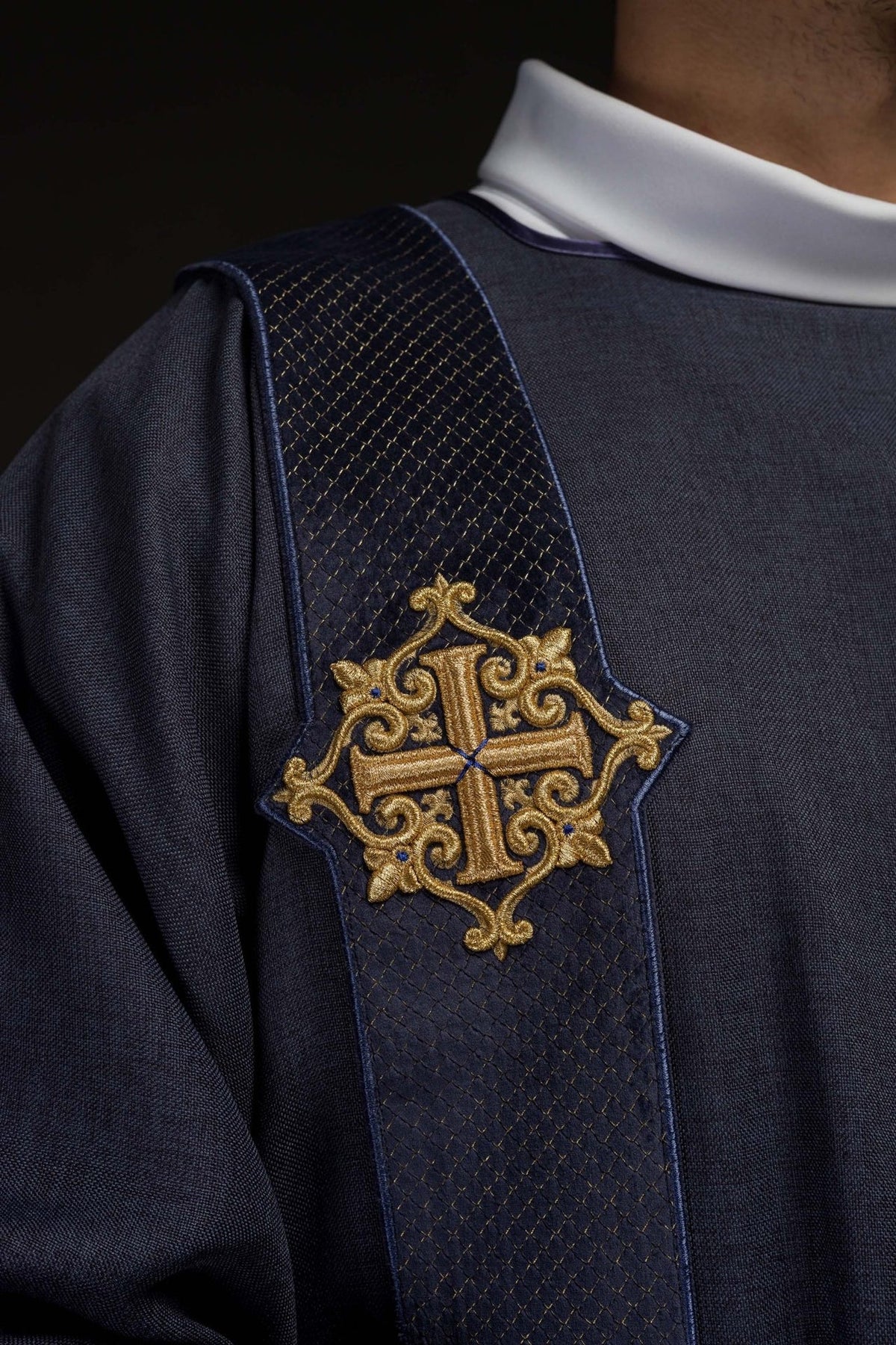 Purple velvet dalmatic sleeve close-up with satin trim