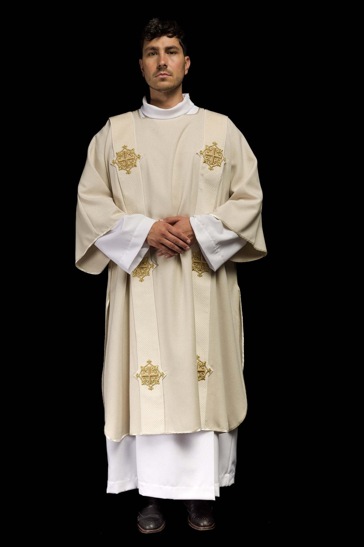 Ecru dalmatic worn in front view with wide sleeves and cross orphreys